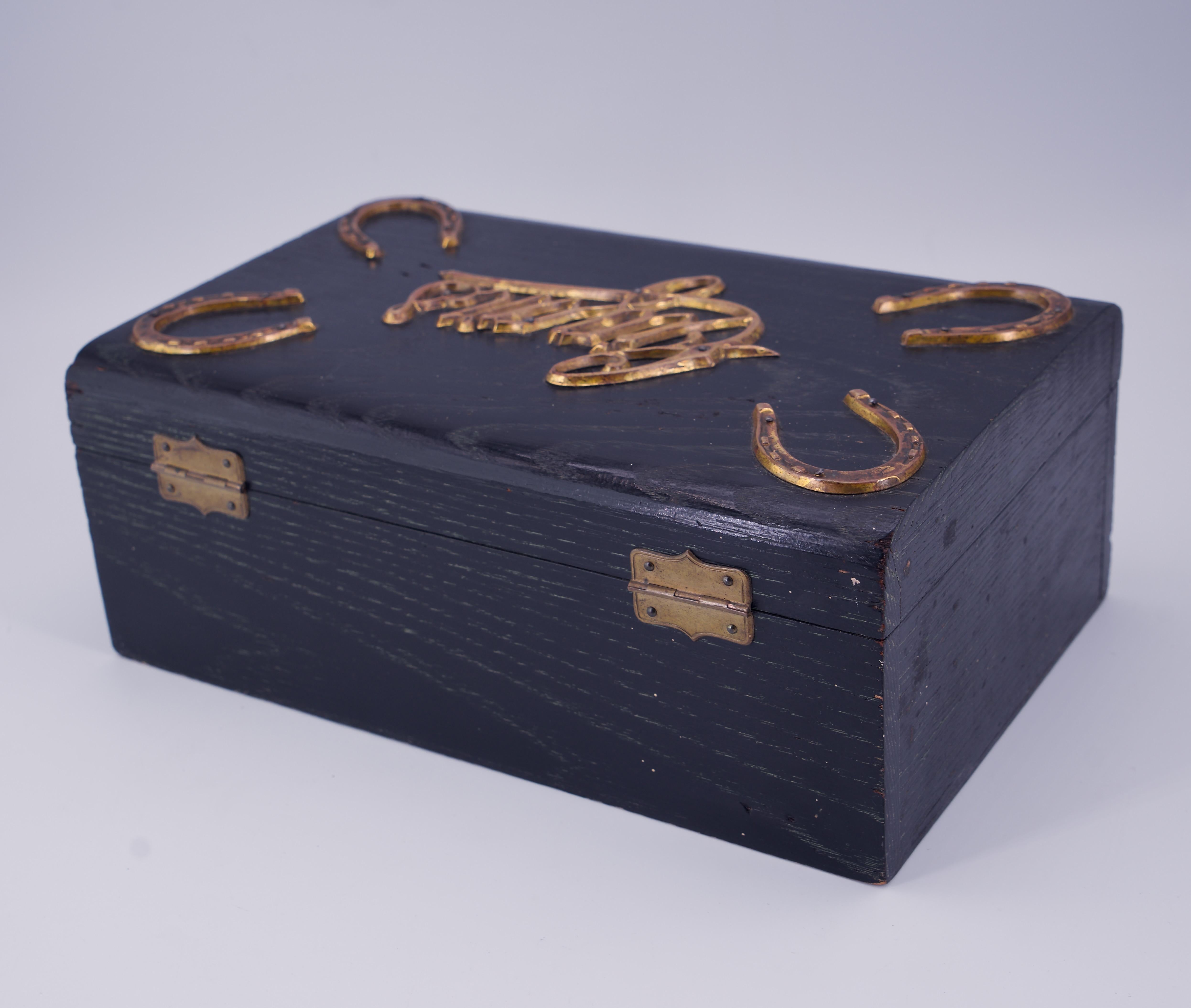 Humidor de puros de roble cerúleo con inscripción de latón y 4 herraduras, cerradura original y llave esquelética.  Interior forrado de estaño. Buen estado de uso.

Exterior An 9 15/16 x Pr 6 3/8 x Al 4 pulg.
Interior An 9 x Pr 5 1/4 x Al 3 pulg.
