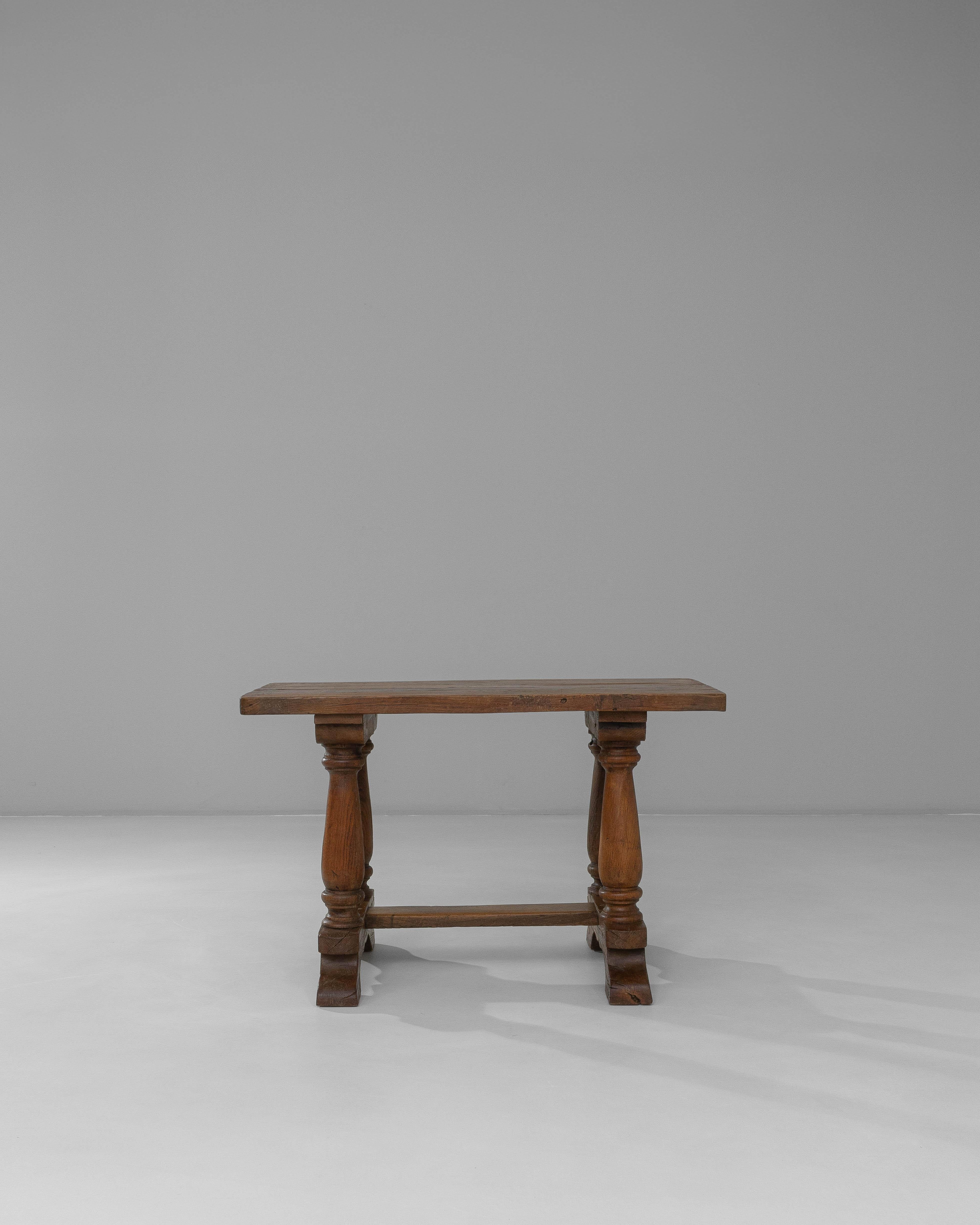 19th Century Luxembourg Provincial Oak Trestle Console Table in Original Patina. This provincial oak console table from 19th-century Luxembourg showcases traditional craftsmanship and a beautifully preserved original patina. The thick rectangular