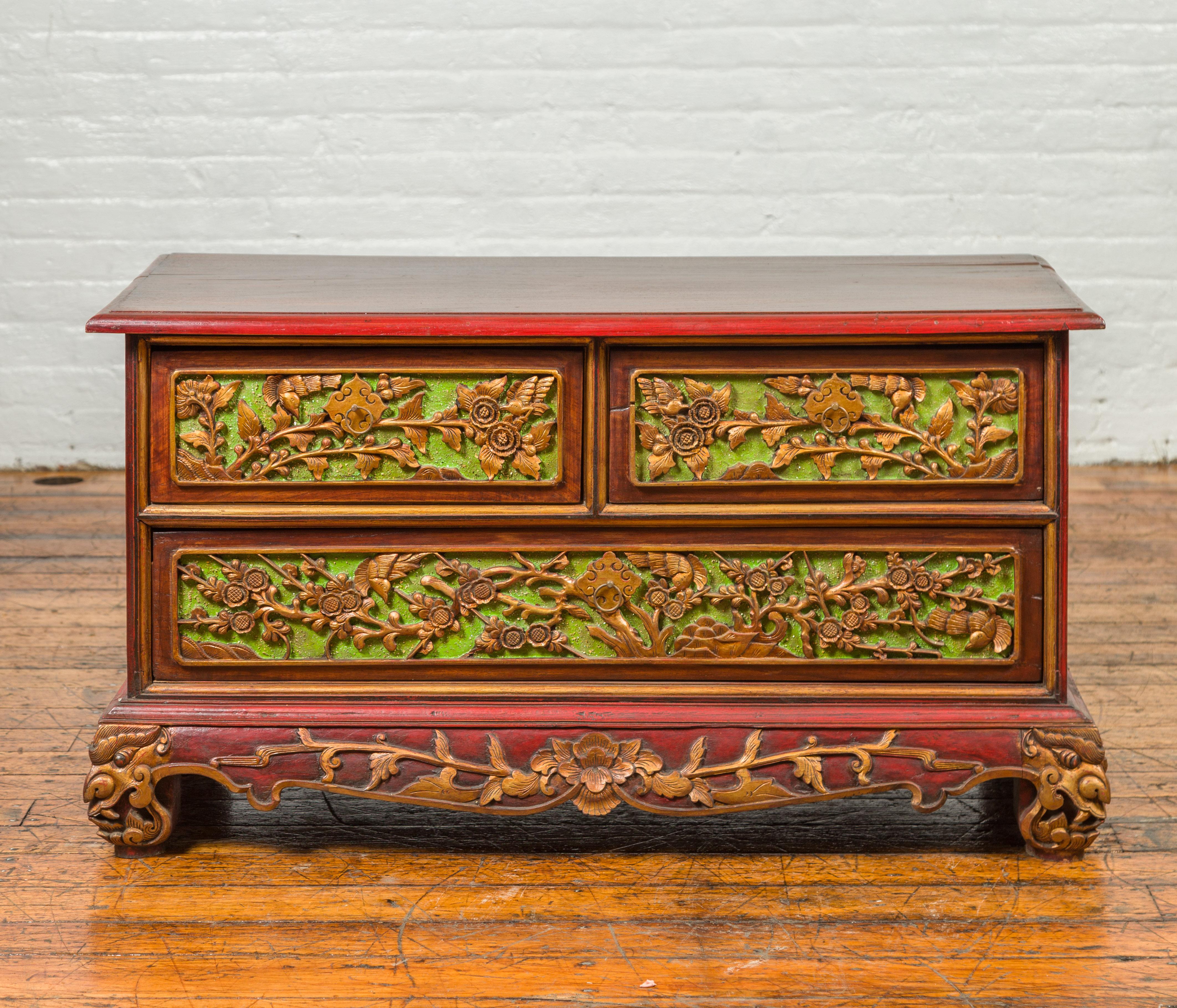 An Indonesian polychrome dresser from Madura with carved drawers and verdigris highlights. Emanating a breathtaking fusion of vivid colors and exquisite craftsmanship, this 19th century Indonesian polychrome dresser from Madura is the quintessence