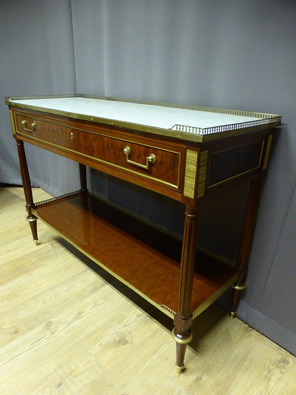 19th century mahogany and gilded bronze Louis XVI style console.
One large drawer. Gilded brass gallery and Carrara marble top.
Scraper gilded bronze. Beautiful quality.
 