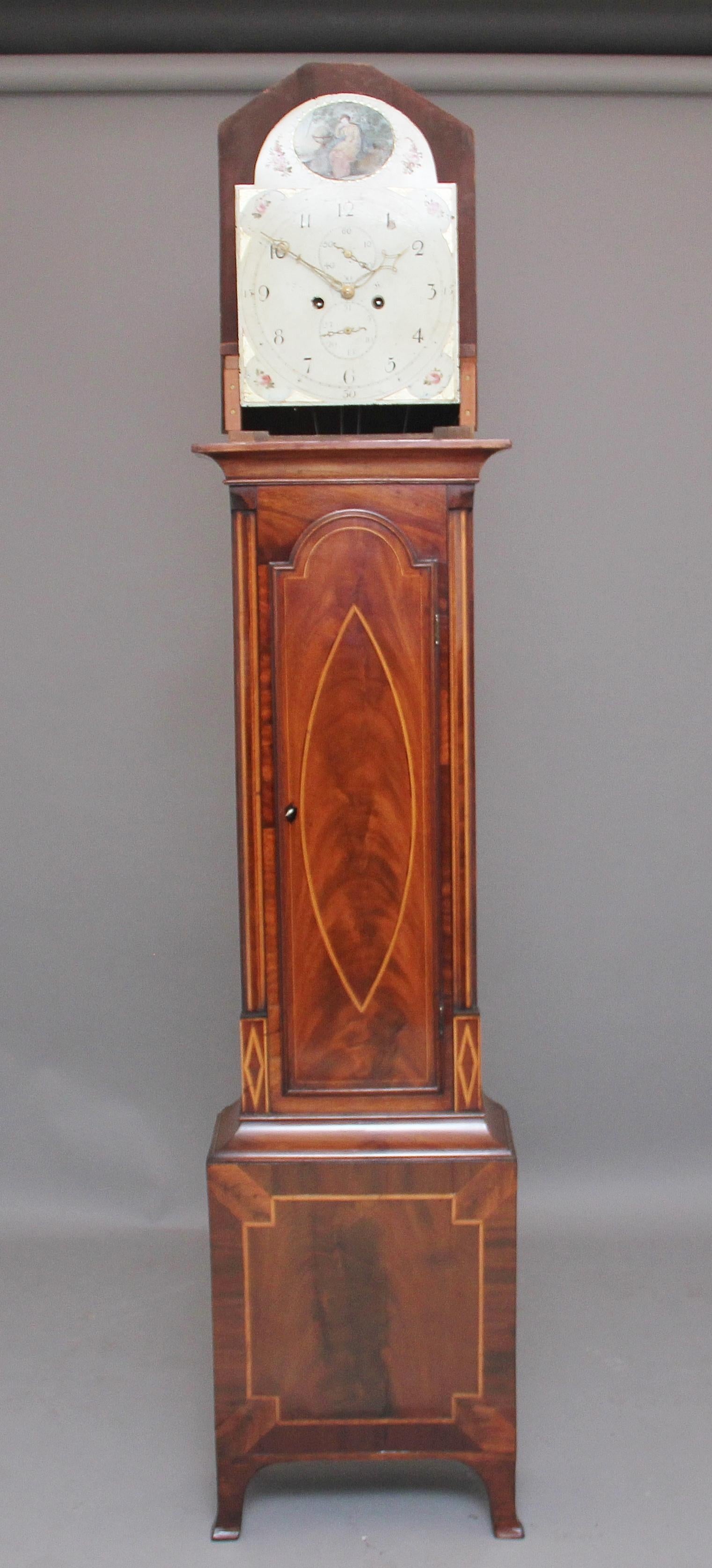 A lovely 19th century mahogany eight day long case clock by Todd of Hull, having an arched painted dial with a seconds dial, the mahogany case has a pagoda shaped hood, the mahogany is inlaid with boxwood and ebony and has a shell inlay at the top,