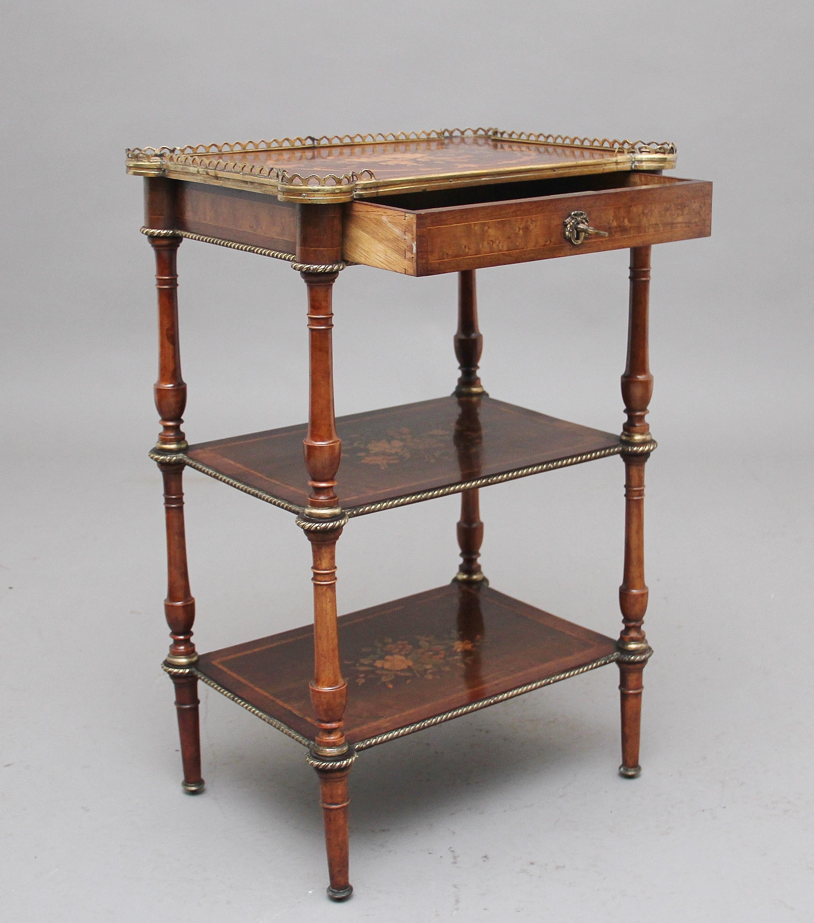 A lovely quality 19th century mahogany inlaid three tier étagère table, each tier having a flora marquetry inlay and decorated with ormolu beading along the edge, the top tier having a pierced brass gallery and below a frieze drawer, the drawer