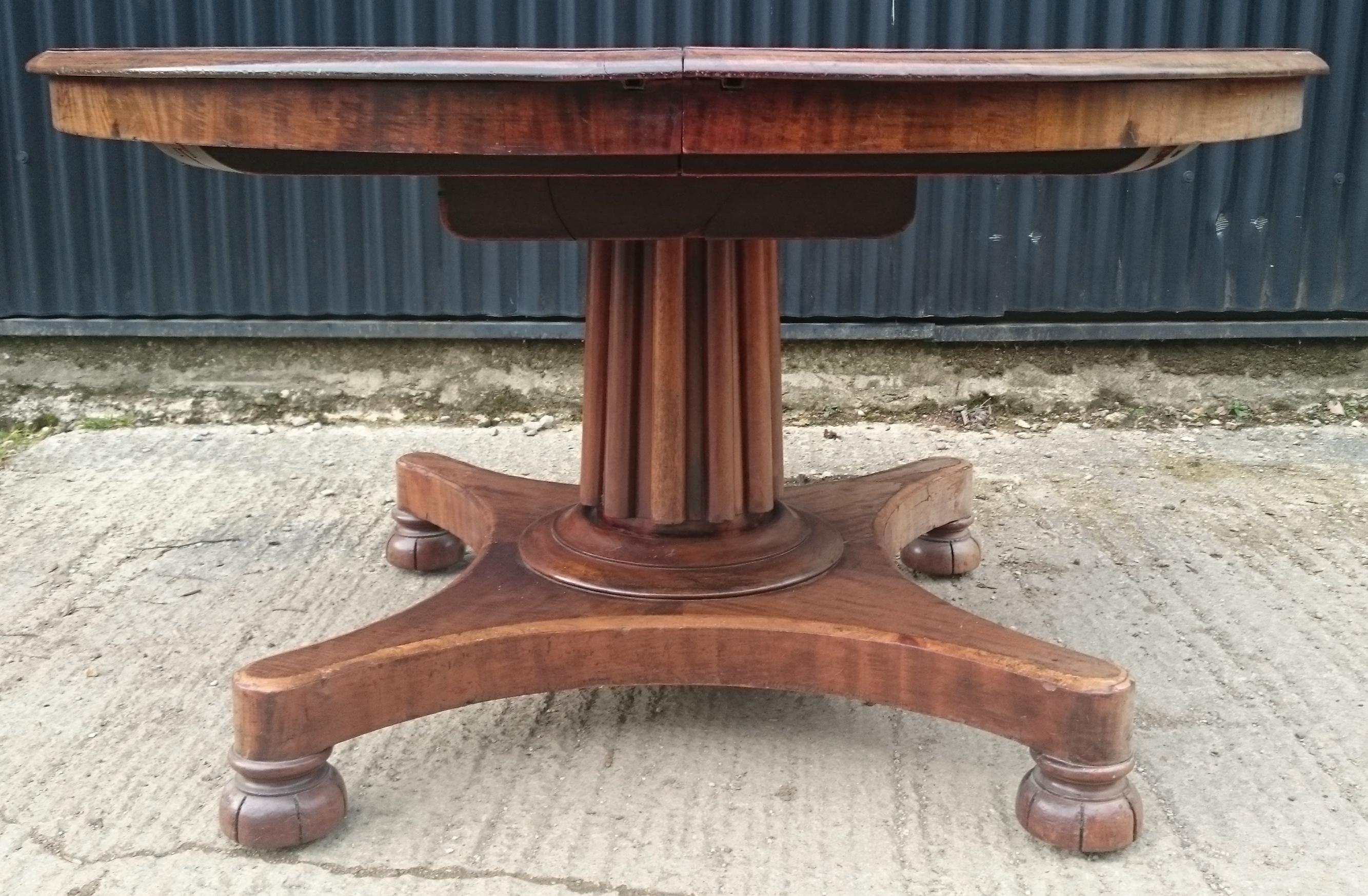 19th century mahogany antique dining table which extends to take two additional leaves to make it six feet long. This table has an unusually pretty reeded column support standing on the slender base and the frieze is good and narrow to give maximum