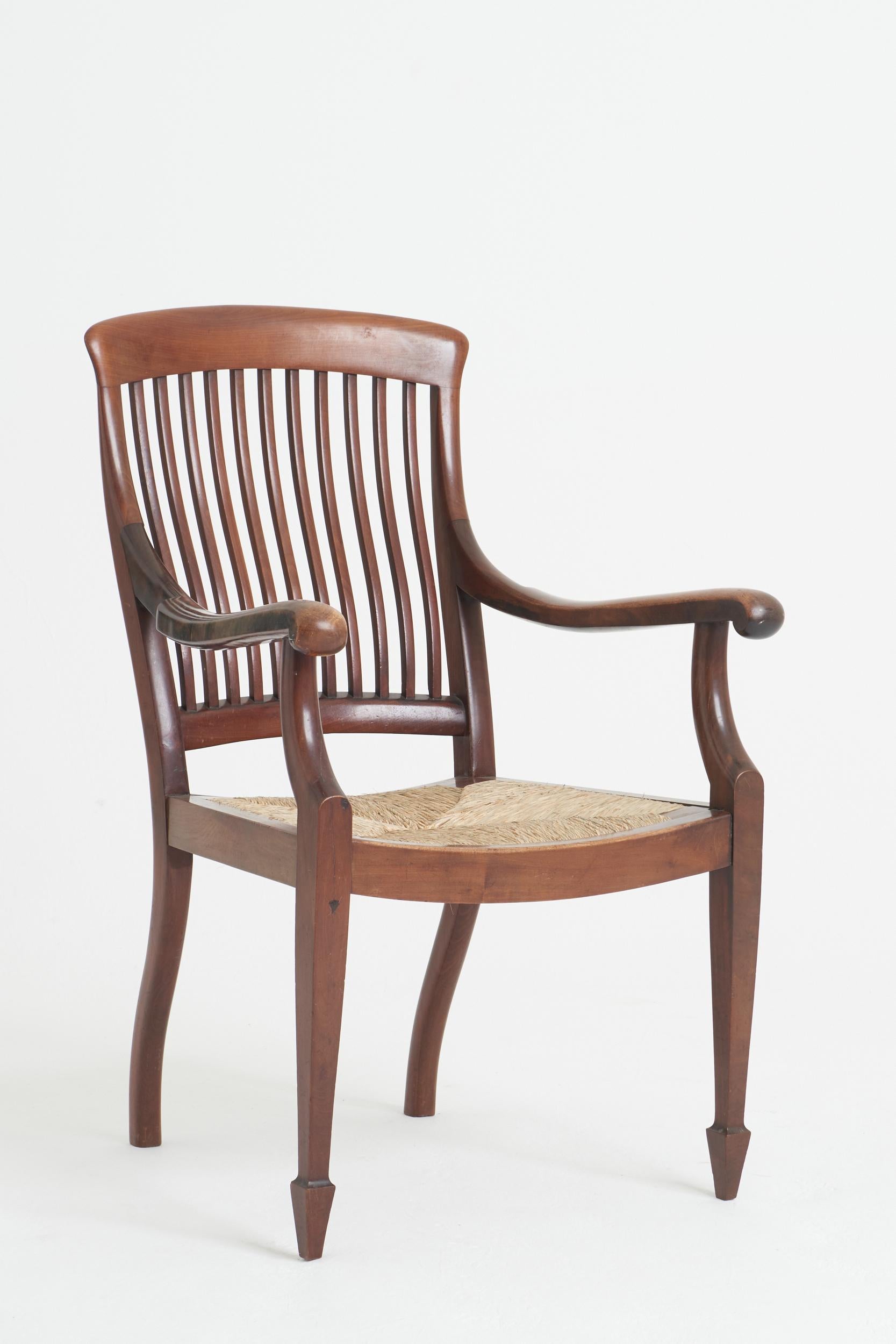 A mahogany and rush armchair.
Back leg stamped with HH initials. 
England, 19th century
98 cm high by 62 cm wide by 66 cm depth, seat height 42 cm.