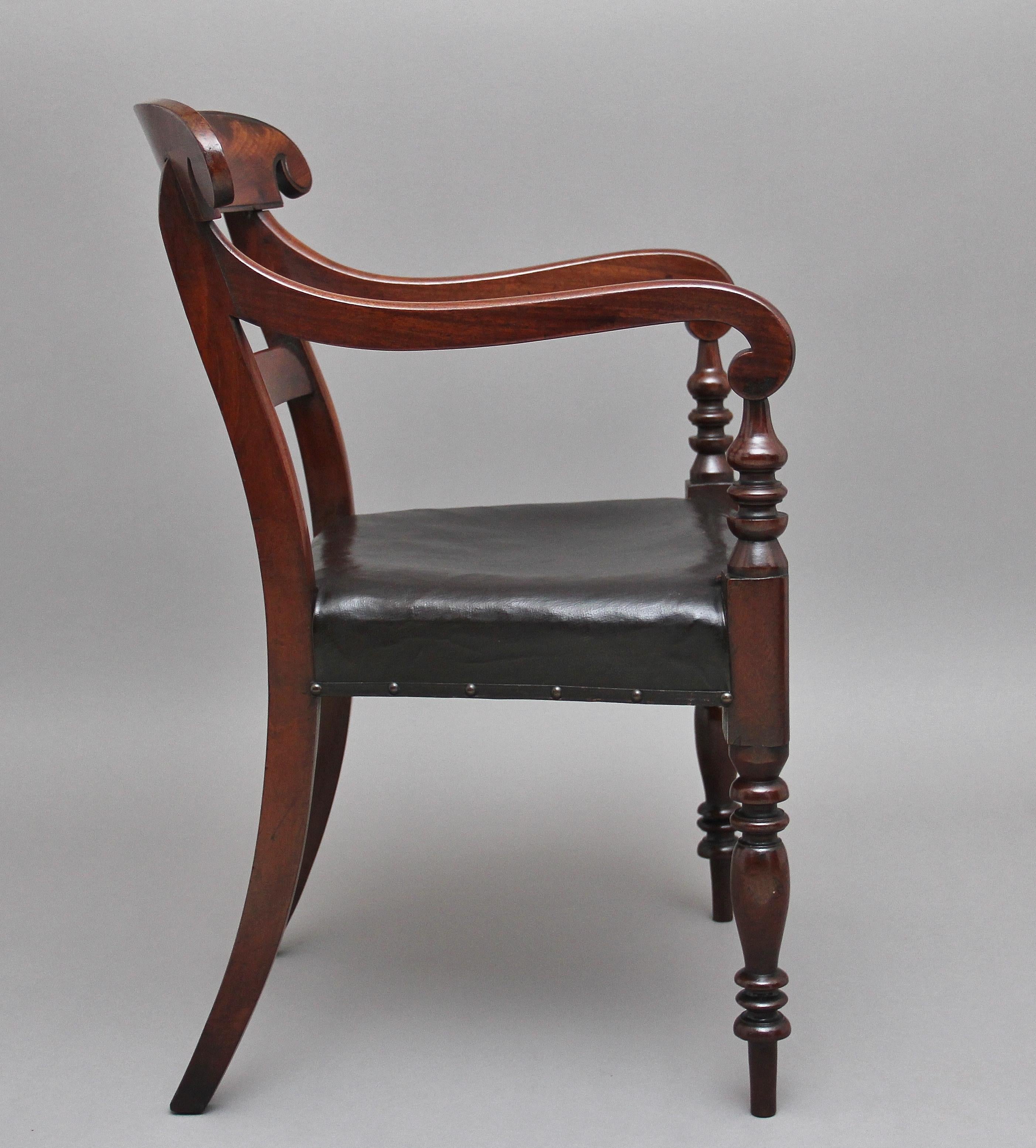 19th century mahogany armchair, having a shaped top rail with scroll ends, central rail below, wonderfully shaped and scroll arms supported on turned uprights, black stuff over seat, standing on out swept rear legs and turned front legs, circa