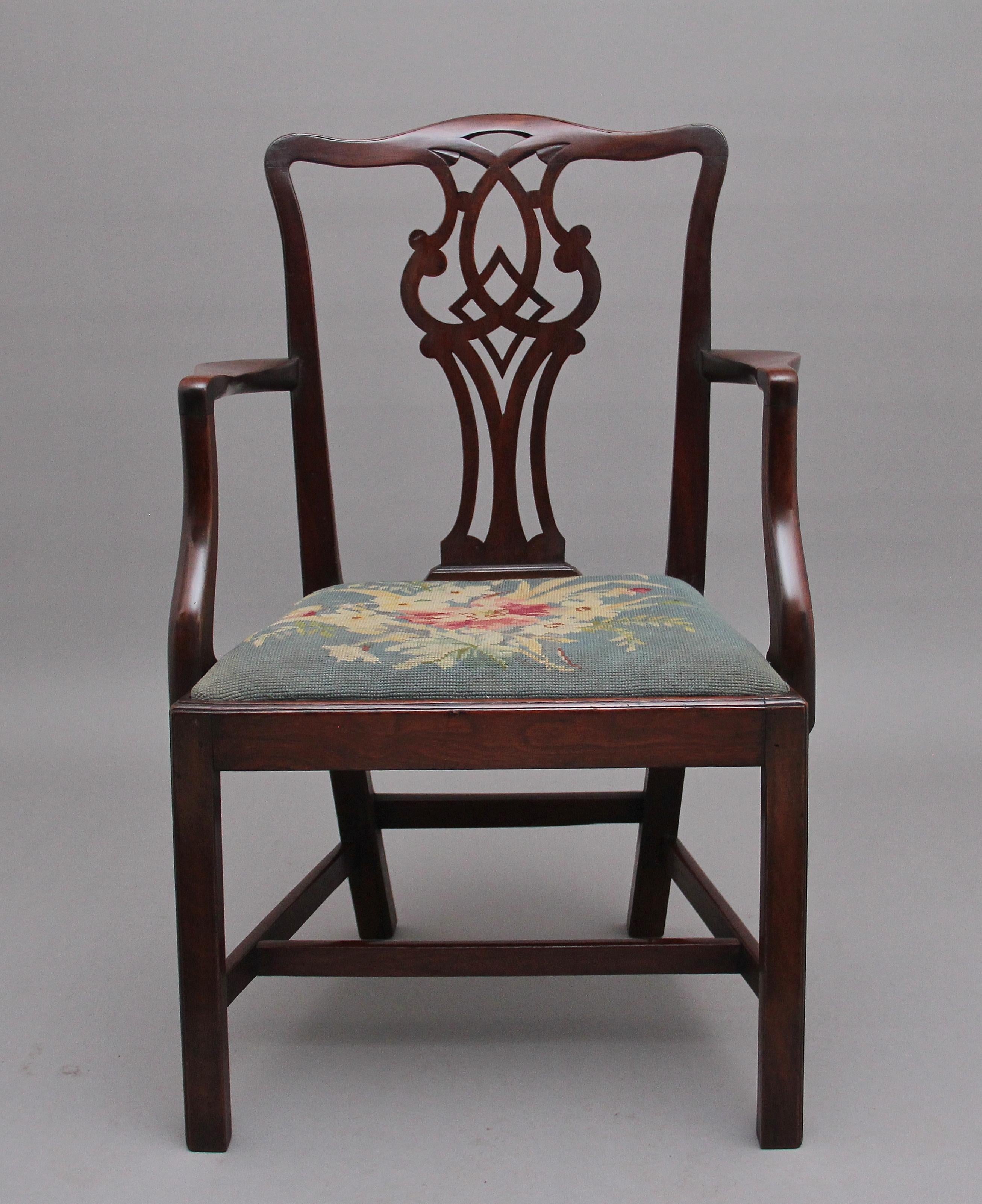 19th Century mahogany armchair in the Chippendale style, with a pierced splat in the back, the slender curved supports leading down to a needlepoint drop in upholstered seat, supported on square legs united with side, front and back stretchers.
