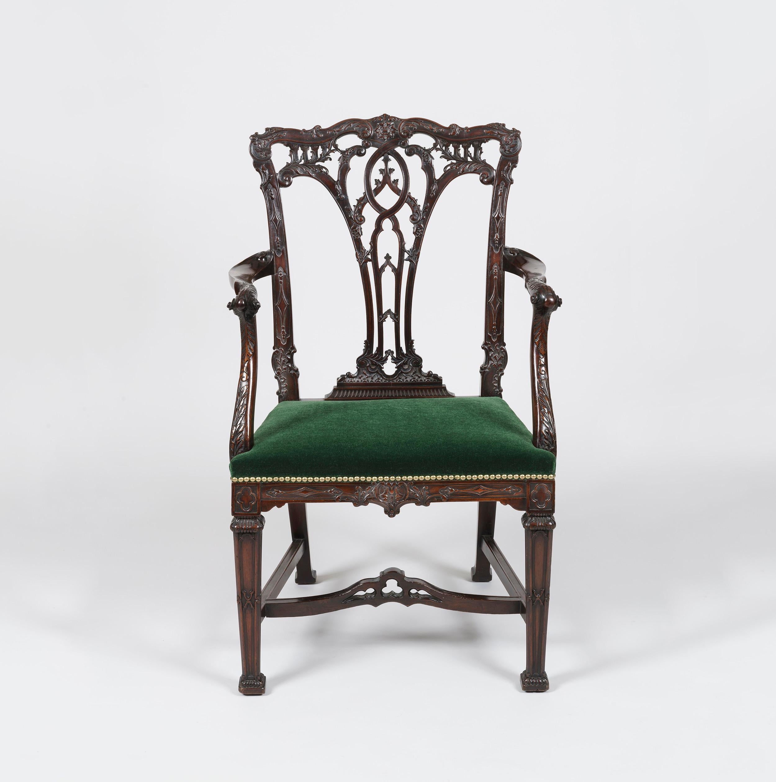 A Fine Armchair in the Manner of Thomas Chippendale

Constructed in richly coloured and crisply carved mahogany, rising from square relief-carved legs having gadrooned terminals and joined with a pierced stretcher to the sabre hind legs. The side