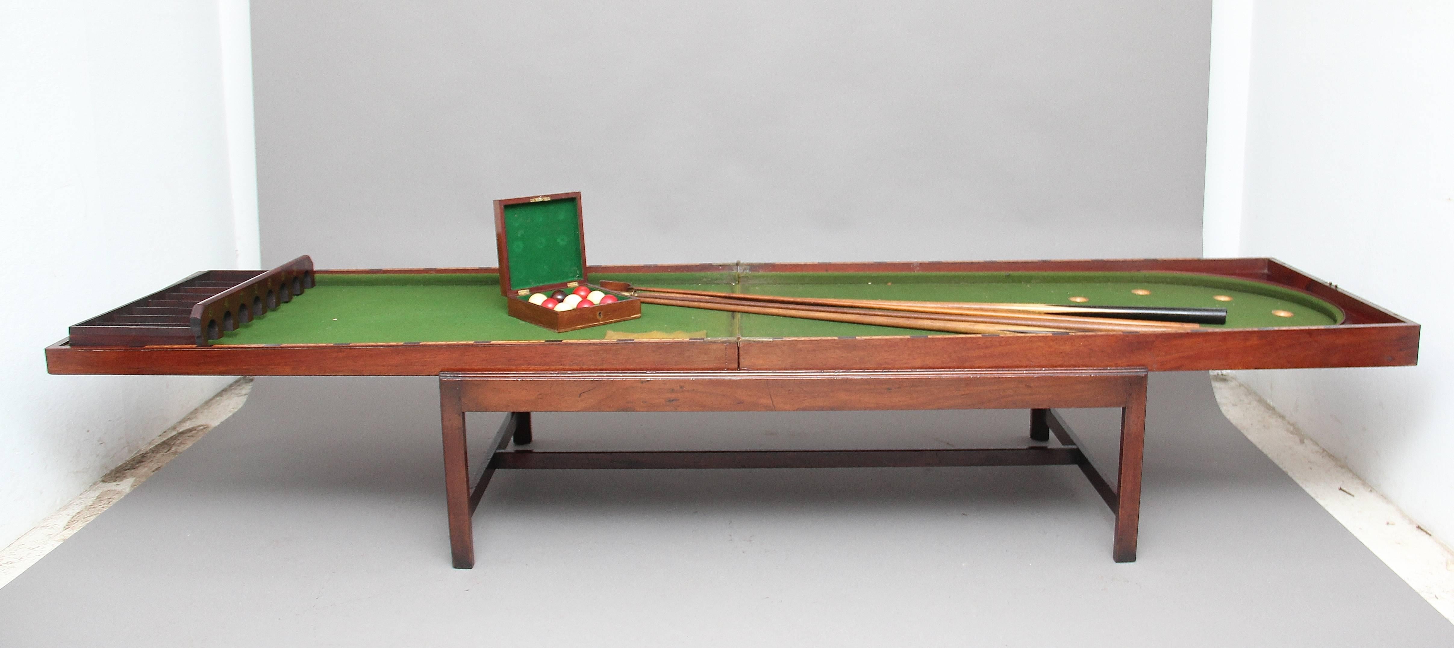 19th century mahogany bagatelle / coffee table on later stand, a very unique piece ideal for use as a coffee table, having a four panel hinged top which opens to reveal the bagatelle games table, which also includes various cues and balls, supported