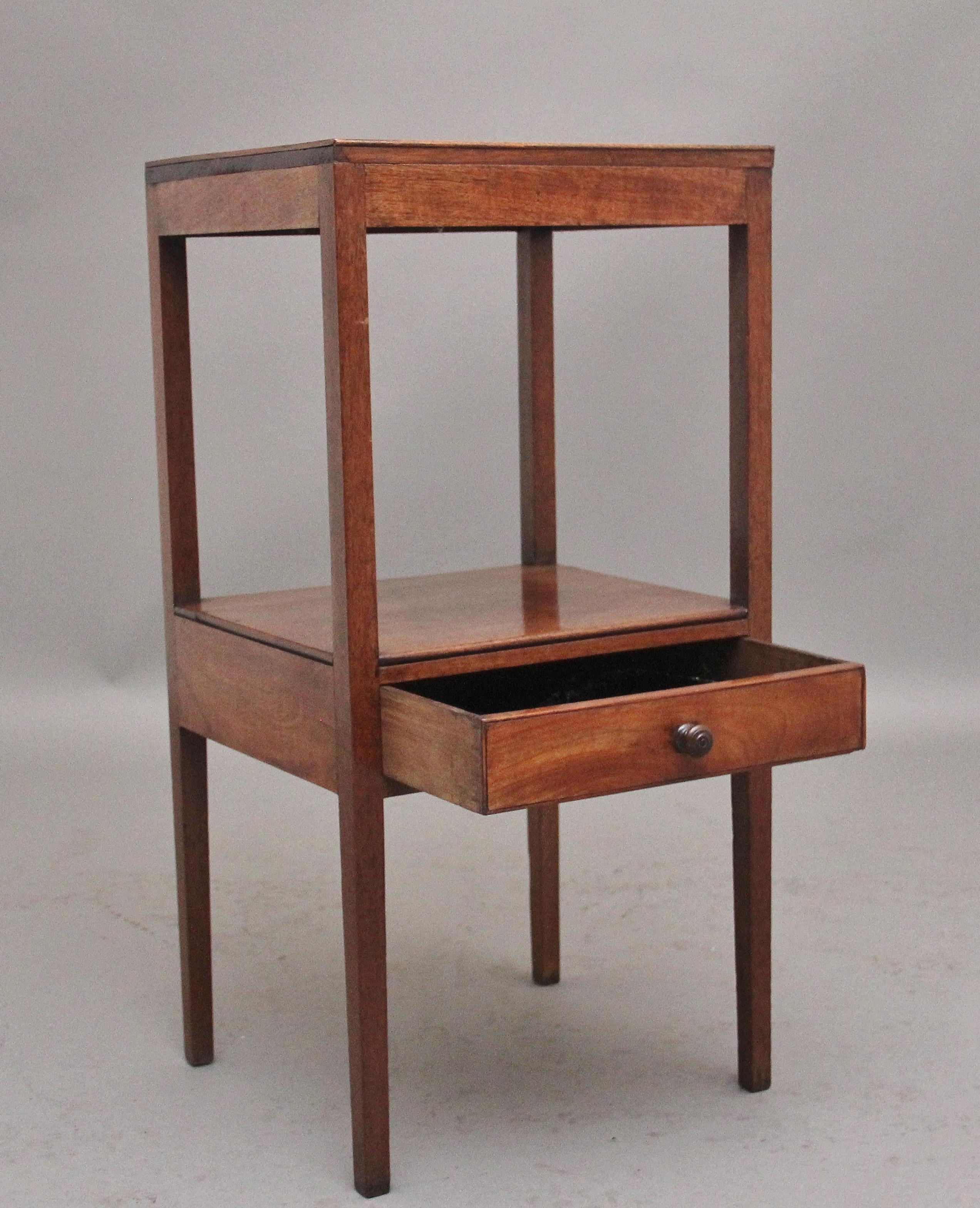 19th Century mahogany bedside table, having a nice figured top and a shelf below with an oak lined frieze drawer with the original turned wooden knob handle, supported on square legs.  Circa 1830.