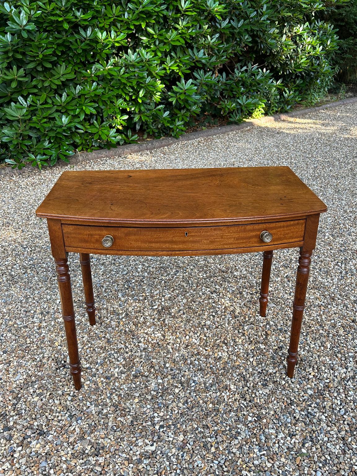 19th Century Georgian Mahogany Bow-Fronted Side Table with single mahogany drawer, round brass handles, on turned supports.

Circa: 1850

Dimensions:
Height:   28.5 inches –  72 cms
Width:    35 inches –  89 cms
Depth:   19.5 inches –  50