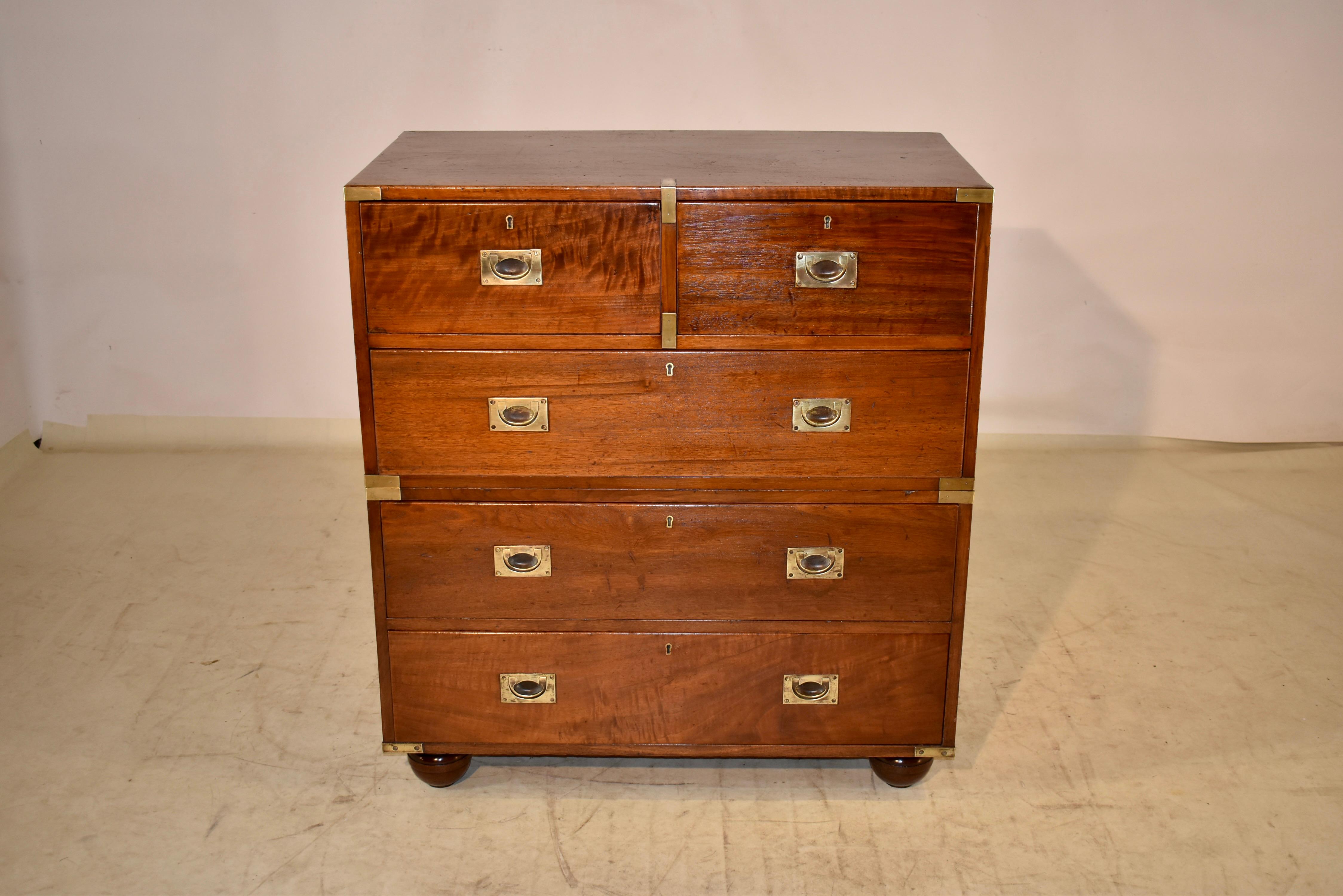 19th century English Campaign chest made form Mahogany. The Campaign pieces were made in pieces that were easy to break down and travel with and go on Campaign with the officers to whom they belonged. The case is banded with brass corners, and has