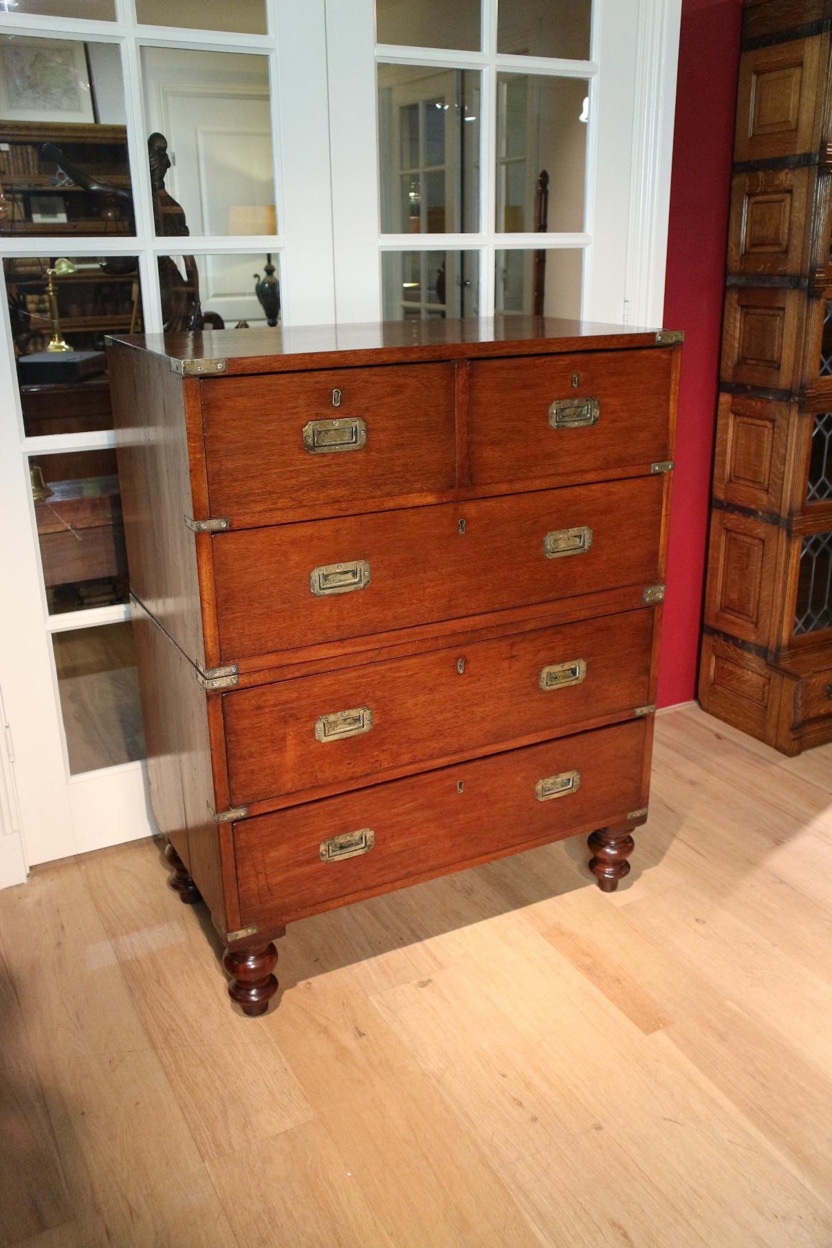 Beautiful mahogany campaign chest of drawers . The chest of drawers is completely in good condition. Nice warm color. The cabinet once had wooden knobs, these have been replaced for the typical military drawer pullers . This have been done long ago