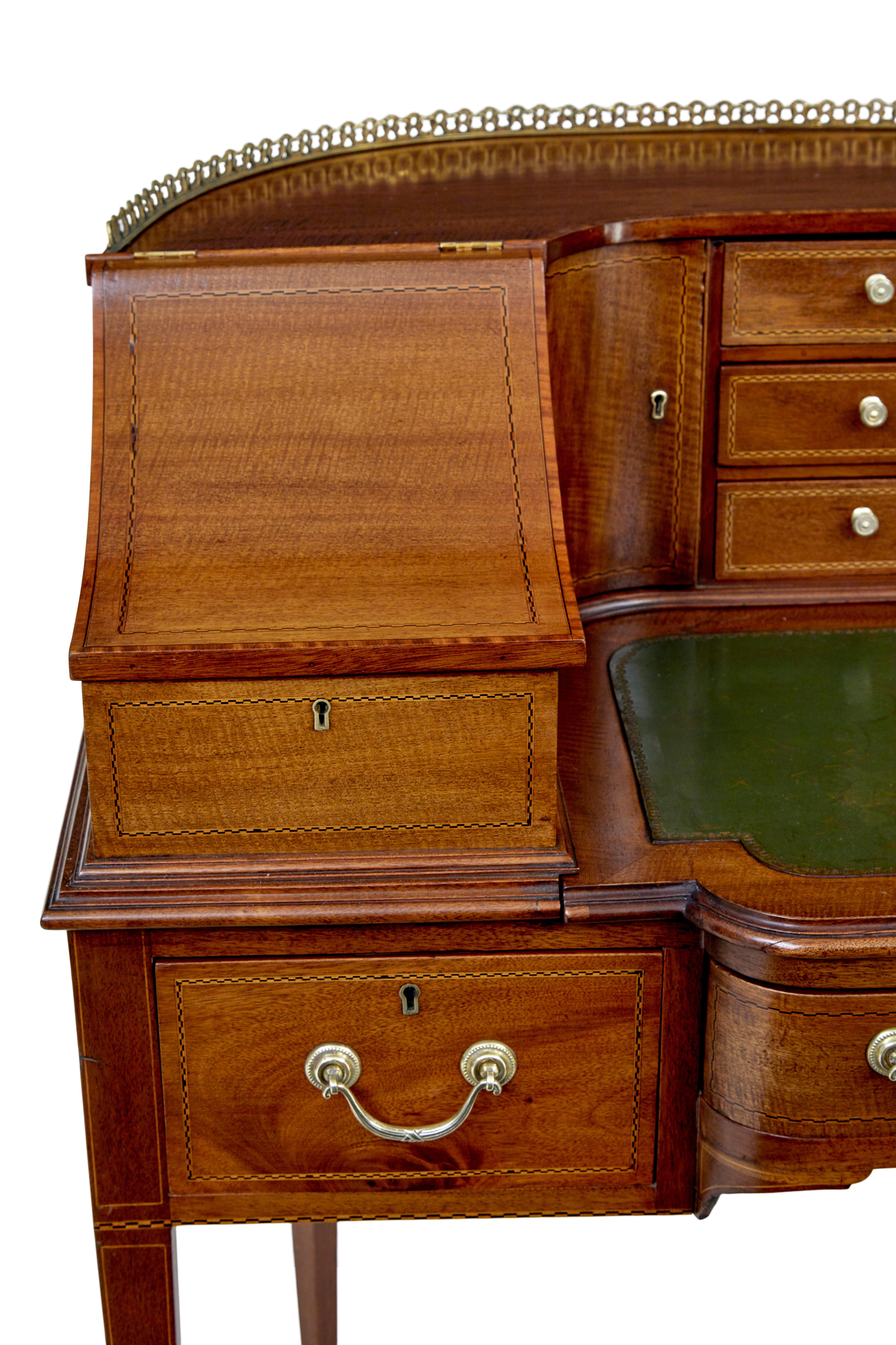 19th century mahogany carlton house desk circa 1890.

Good quality late victorian example of this popular desk design.  Freestanding with shaped back, brass gallery to the top, below which are an arrangement of six inlaid drawers with a central
