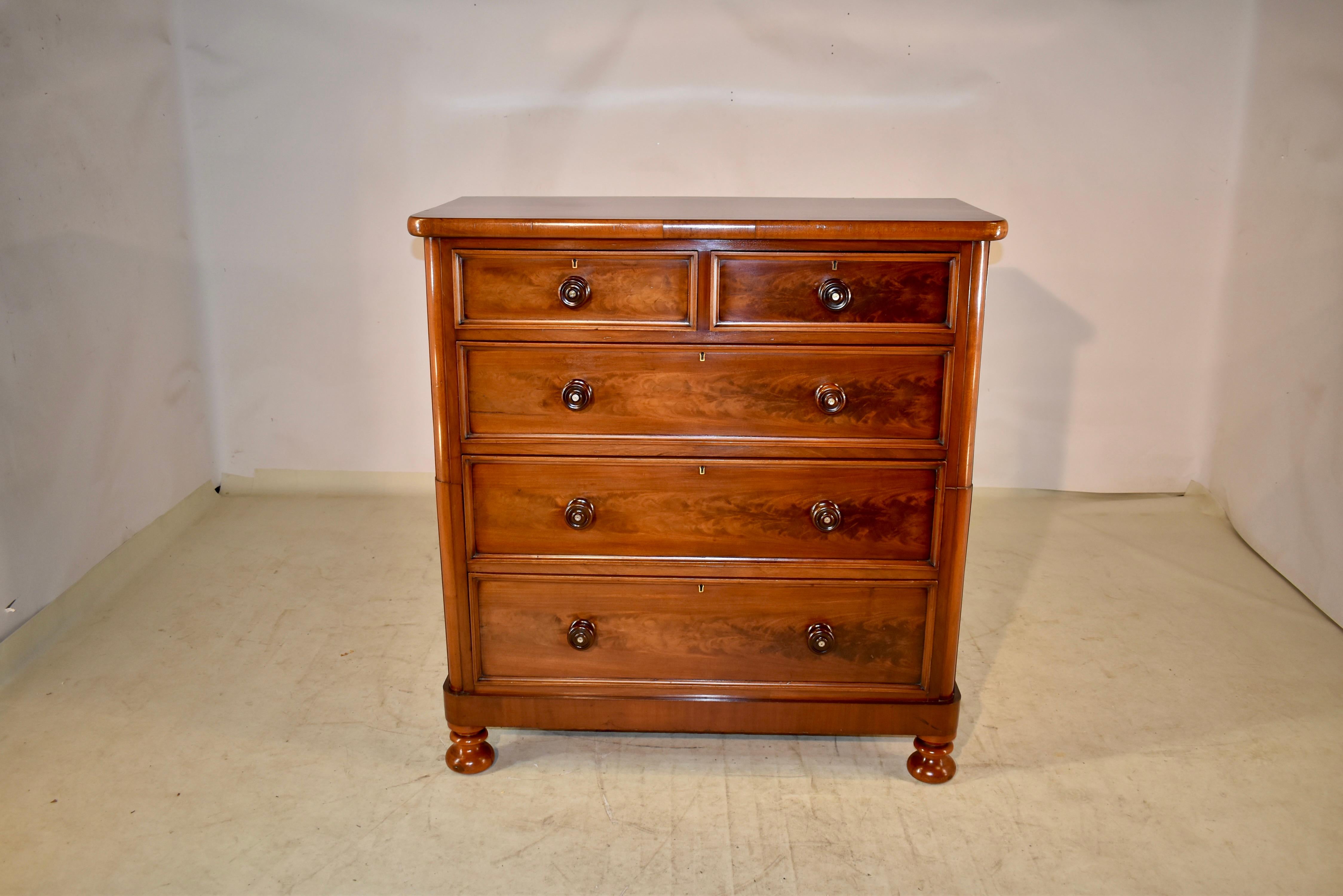 19th century mahogany chest of drawers from England with a wonderfully grained top with a simple banded edge, following down to simple sides. The case has two drawers over three drawers, all of which are beautifully flame grained and have molded