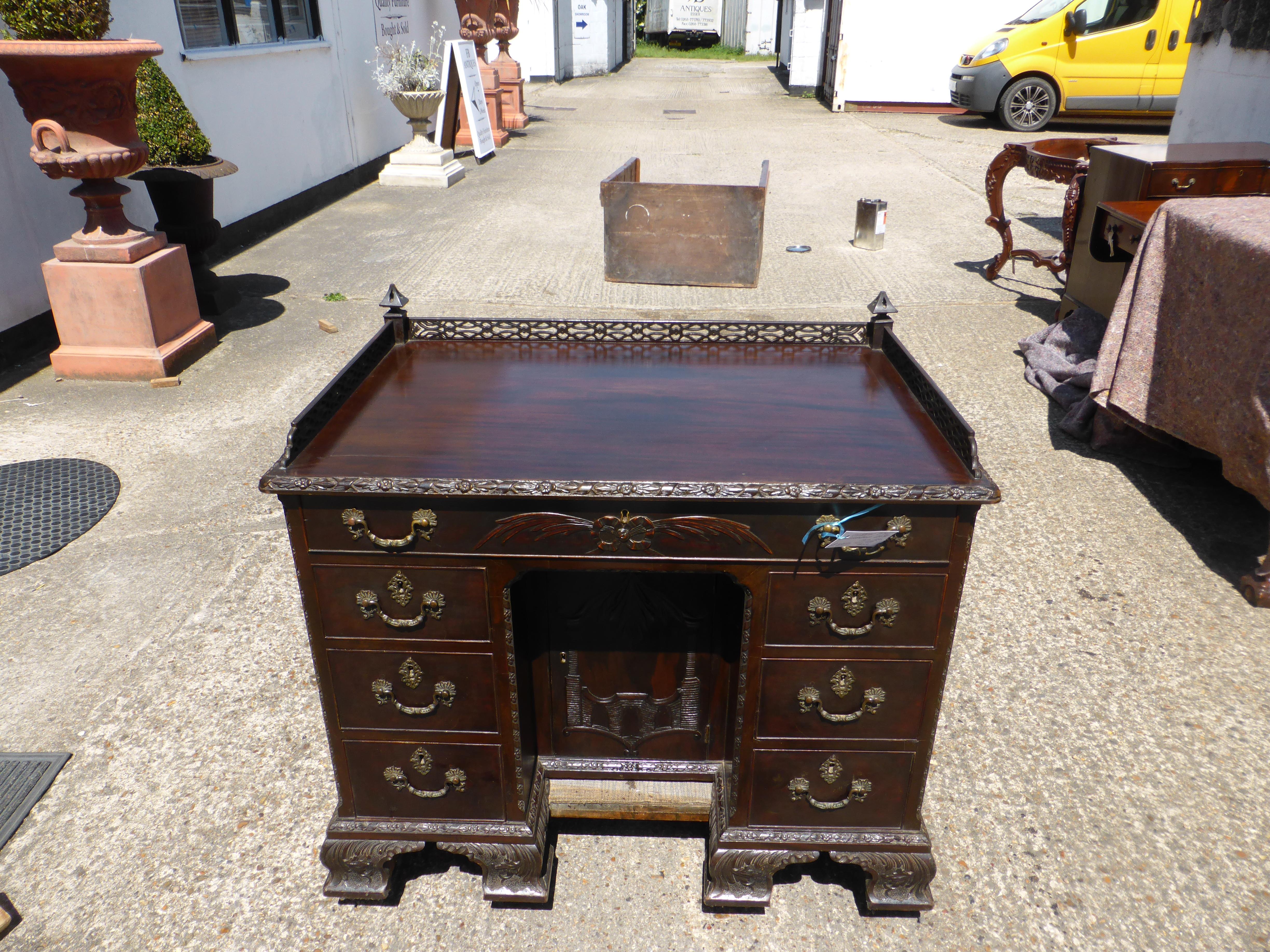 For sale is a good quality carved Chinese Chippendale style kneehole desk. The top of the desk has an intricately fretted gallery which is in perfect condition. Below this the desk has three drawers at the top, one long in the centre with one short