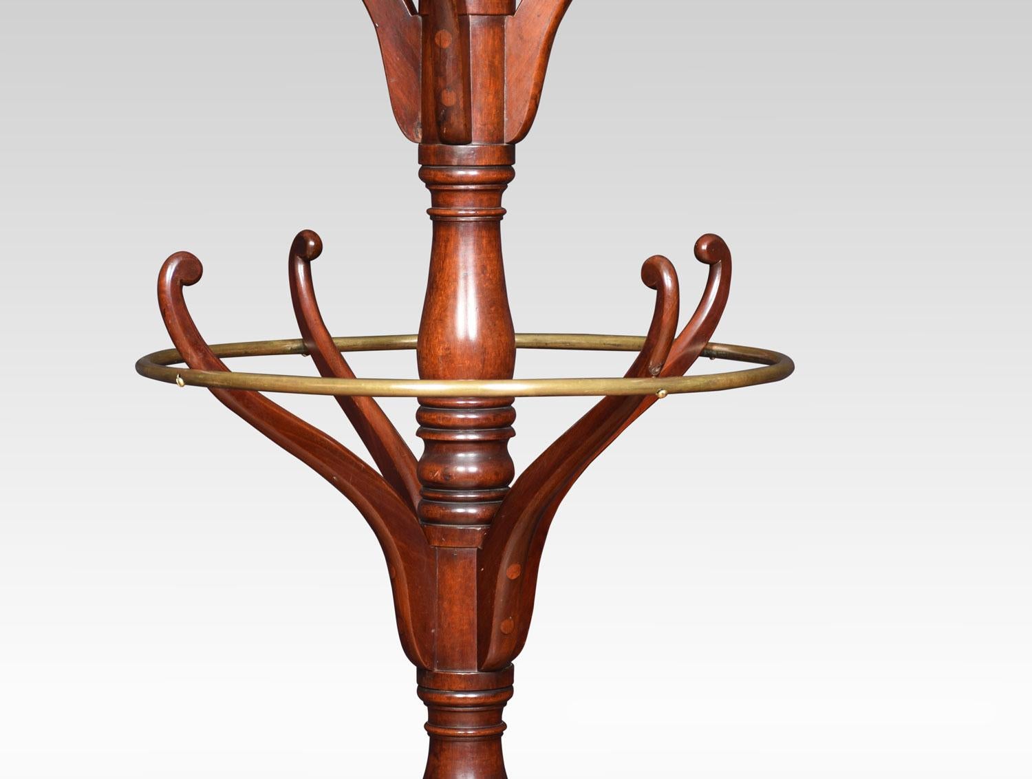 19th century mahogany coat and umbrella stand. The top having two flat arms above two sets of four shaped coat hooks. The centre fitted with unusual with brass circular rail and four hooks below. All raised up on splayed legs united by under