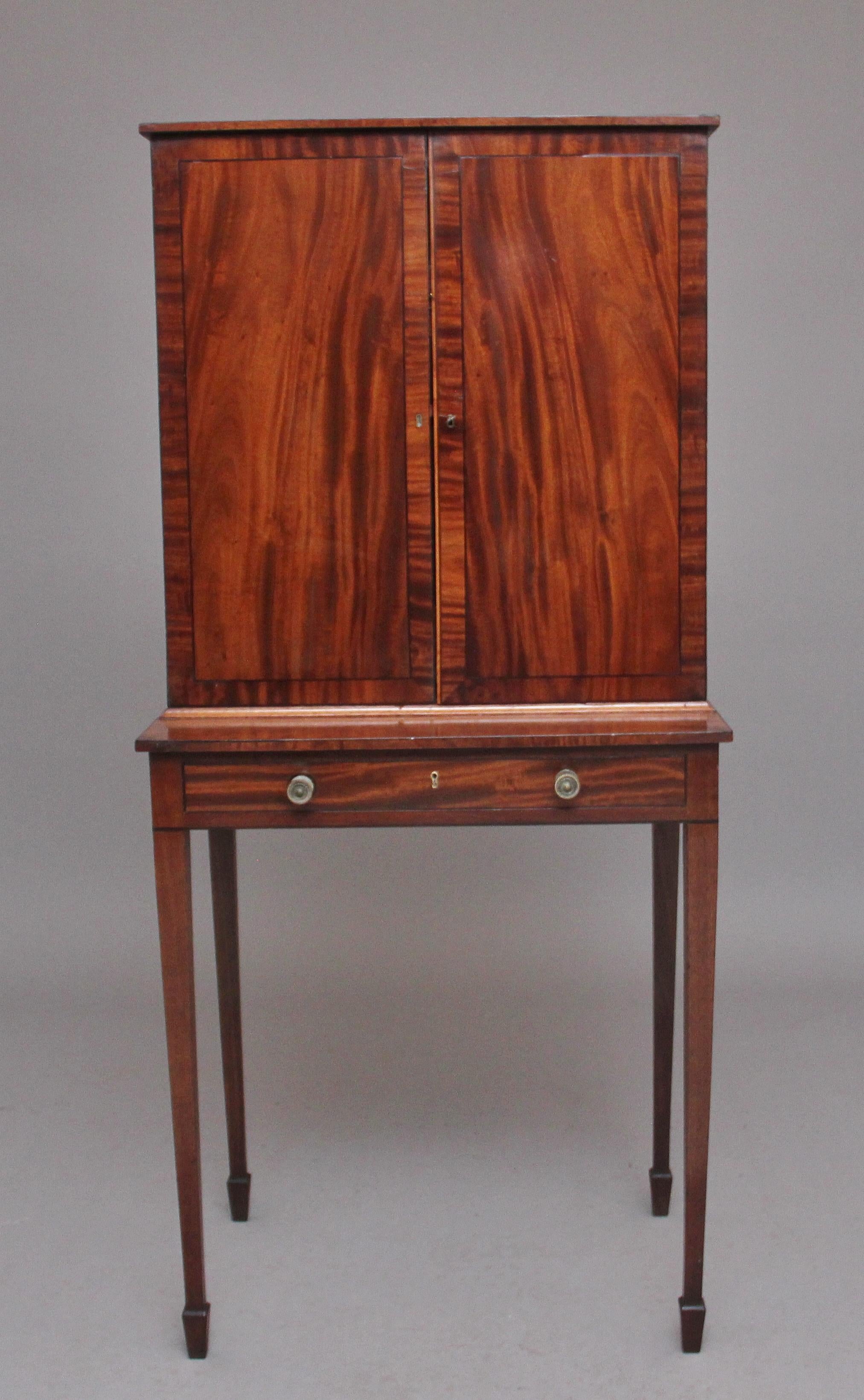 Early 19th century mahogany collectors cabinet, two flame mahogany and crossbanded doors opening to reveal six compartment spaces at the top and ten oak lined drawers below which consist of three drawers at the top, six drawers in the centre and a