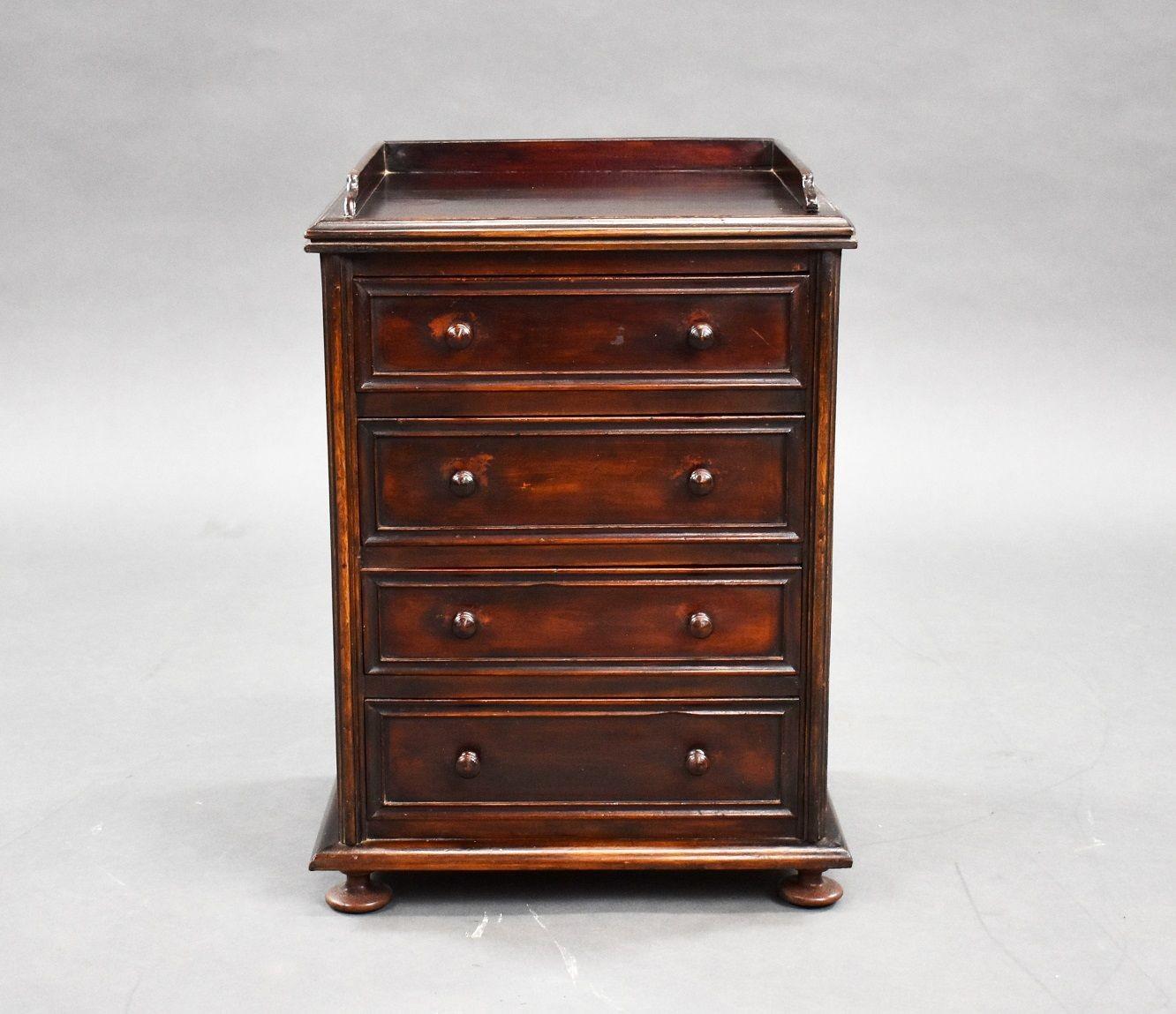 19th Century Mahogany Collectors chest with low gallery to the top and four drawers with knob handles standing on four turned feet.