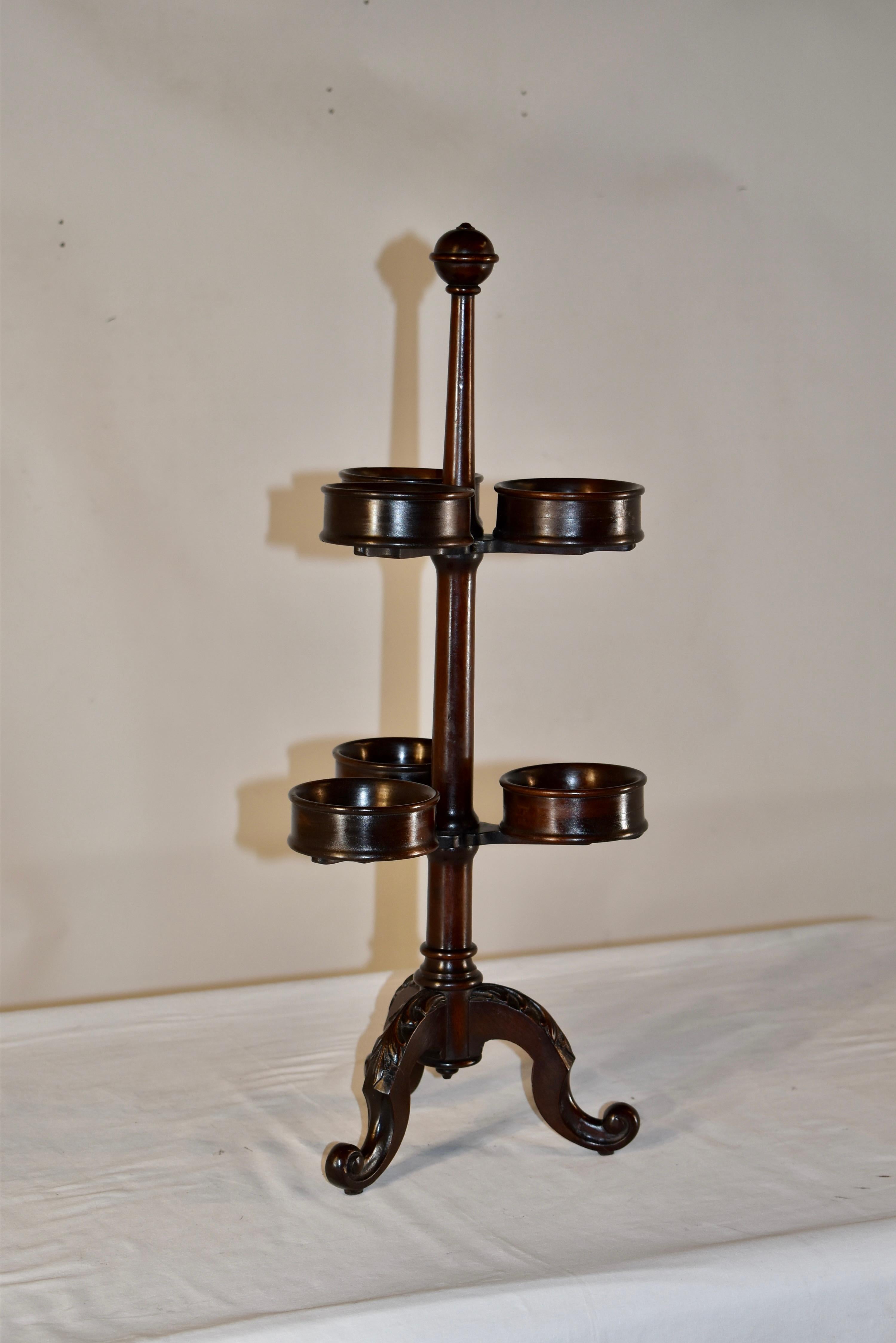 19th century hand turned mahogany condiment stand from England.  These were used on tables or buffets for serving condiments, so you could have them all in one place.  Sometimes people now use them with small crystal cups for flowers or small