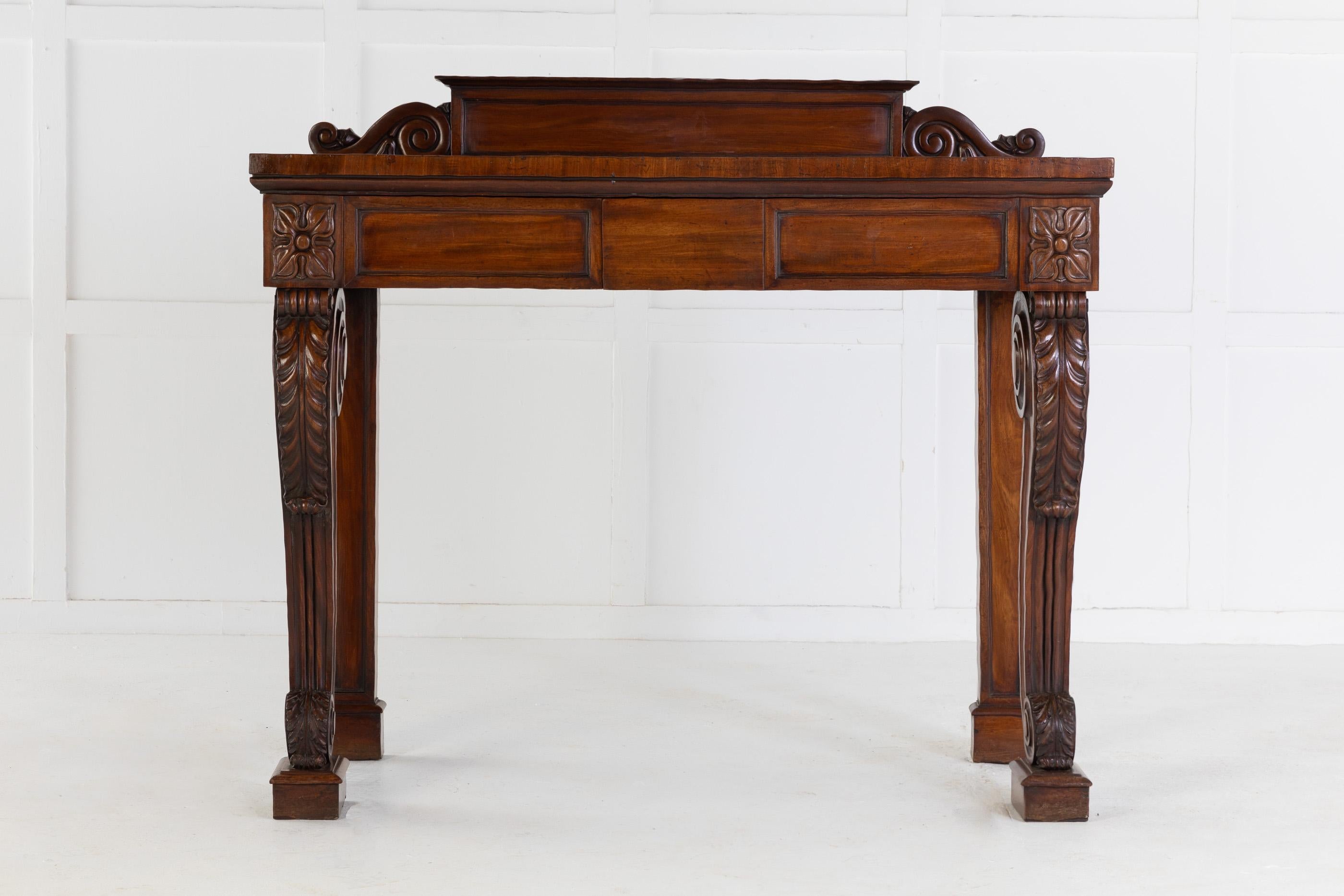 Good 19th century Regency console/side table, stamped by 'Gillows'. A rectangular top, with shallow up-stand, flanked with carved scrolled ends.

Having two frieze drawers and raised on well scrolled support legs, heavily carved with acanthus