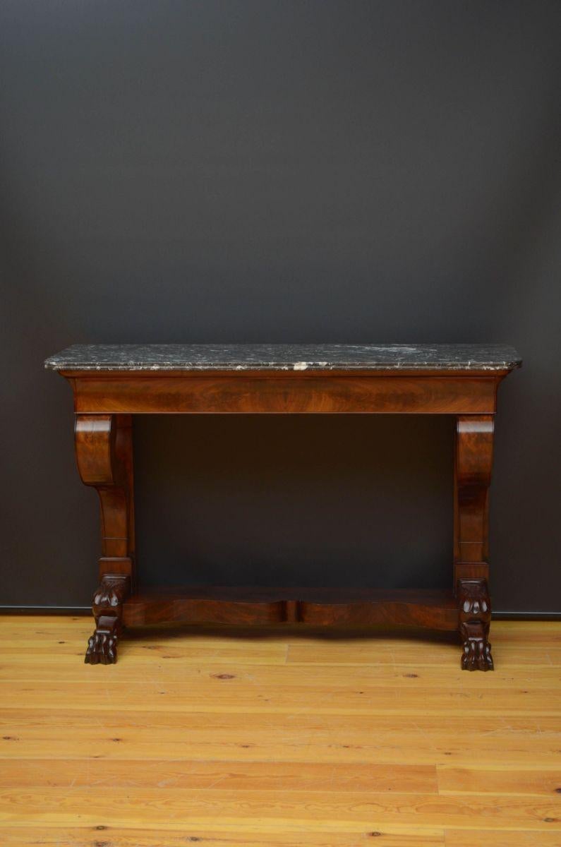 Sn5230 French XIXth century hall table in mahogany, having original granite top with reeded edge above flamed mahogany, oak lined drawer, all standing on shaped supports terminating in carved paw feet united by shaped, flamed mahogany base. This