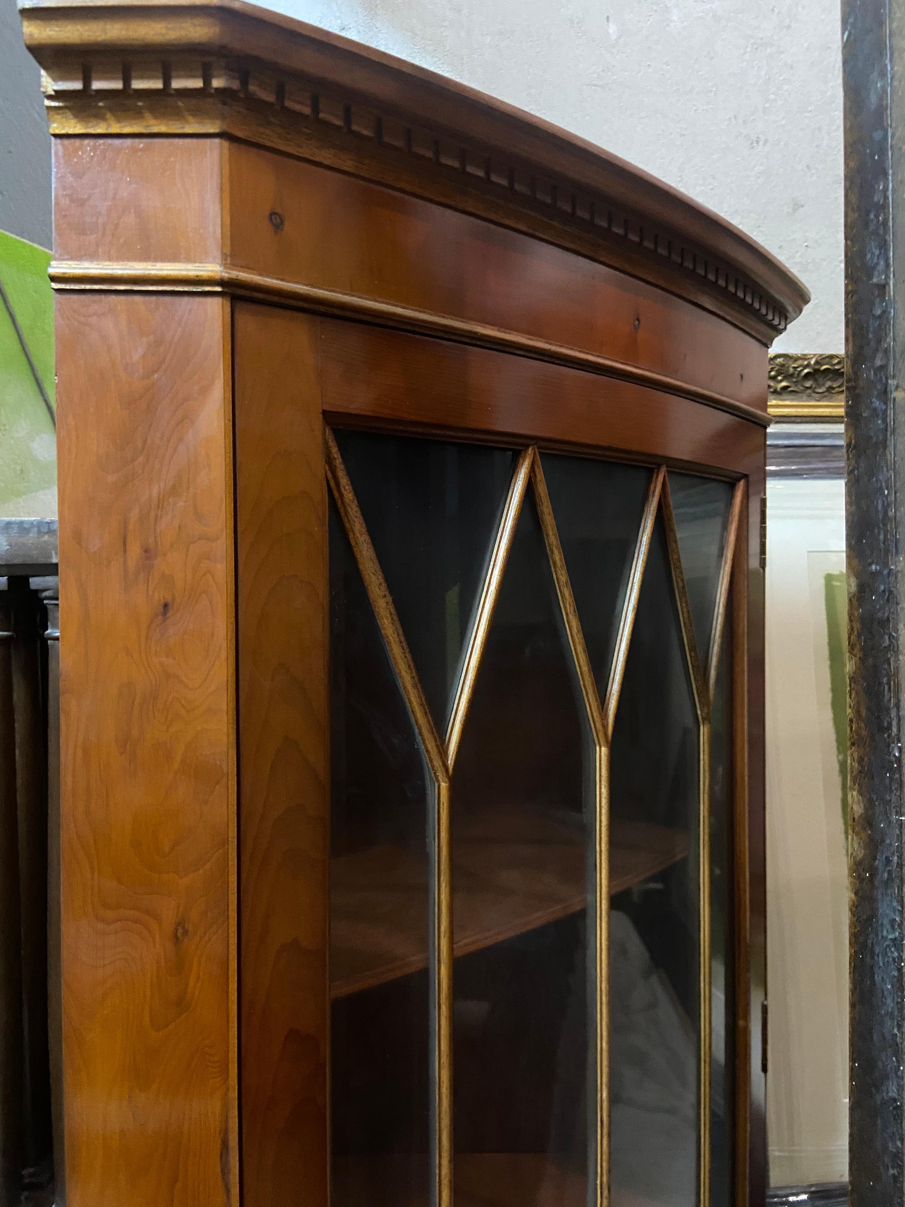 19th Century mahogany corner vitrine with a glass door facade in cathedral shape.
France,
circa 1890