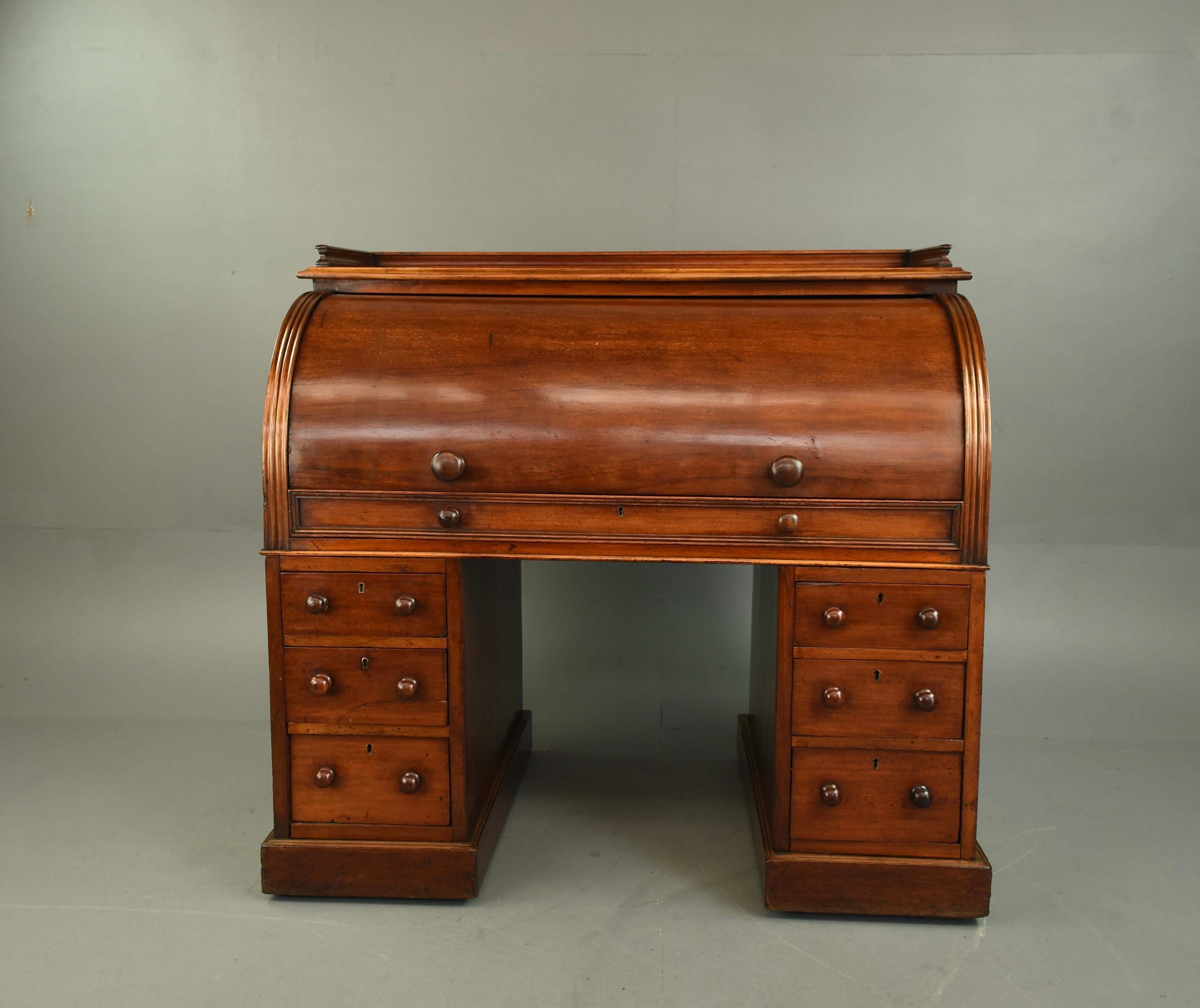 Wonderful Victorian mahogany cylinder top desk circa 1860 .
The desk has a large slide out work top with three inset leather surfaces the centre insert lifts and can be adjustable ,the left hand panel lifts to reveal a well and secret drawer , the