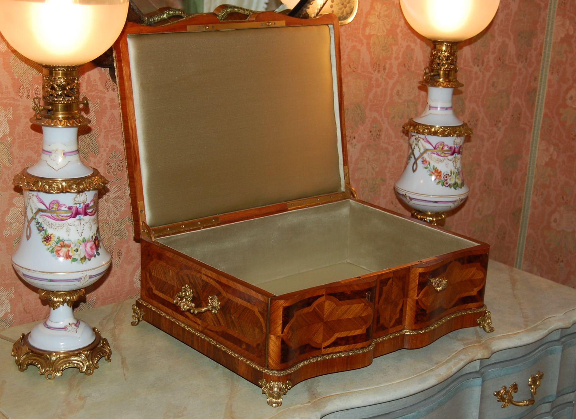 A grand size neoclassical style dresser box used for jewelry or documents with Parquetry designs on the lid and all four sides, possibly Russian in origin. Decorative brass bands run the perimeter of the lid and the base, with four brass feet and