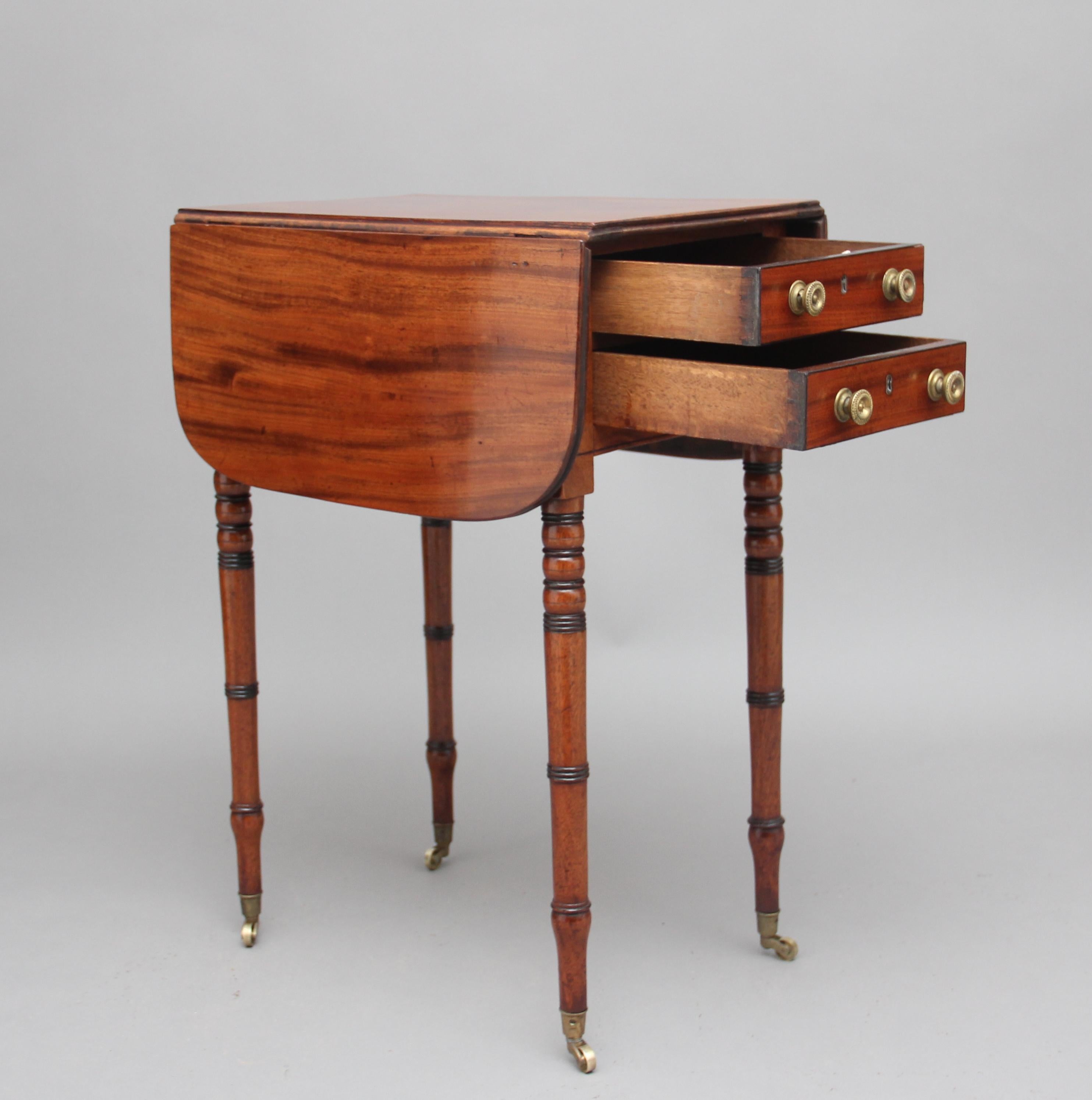 19th century mahogany drop leaf or side table, the drop leaf opens up and extends to 30” (76cms) having two oak lined drawers with original brass turned knob handles, the same on the reverse but with faux drawers, standing on turned feet terminating
