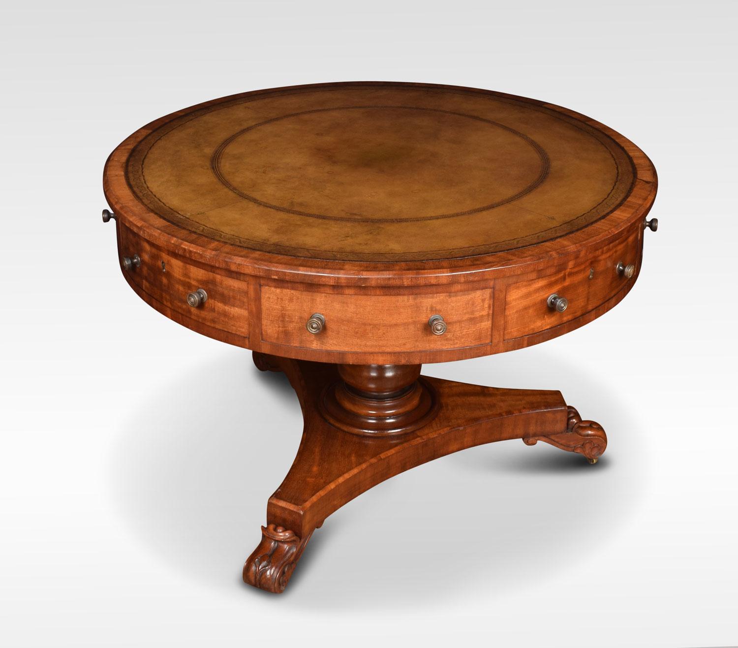 19th century mahogany pedestal drum table. The circular top with inset green and gilt tooled leather. Fitted with four drawers and four false drawers. All raised up on turned pedestal on trefoil platform. Terminating in scroll carved feet with