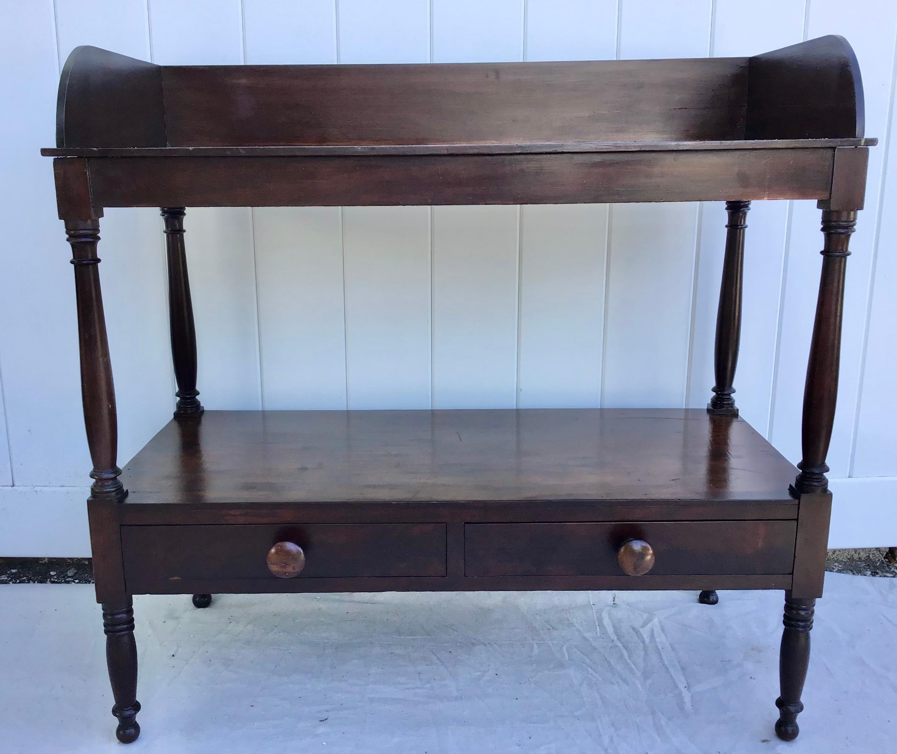 19th century mahogany Etagere featuring a slash back around the top. Two tiers ans two drawers. Standing on turned legs.