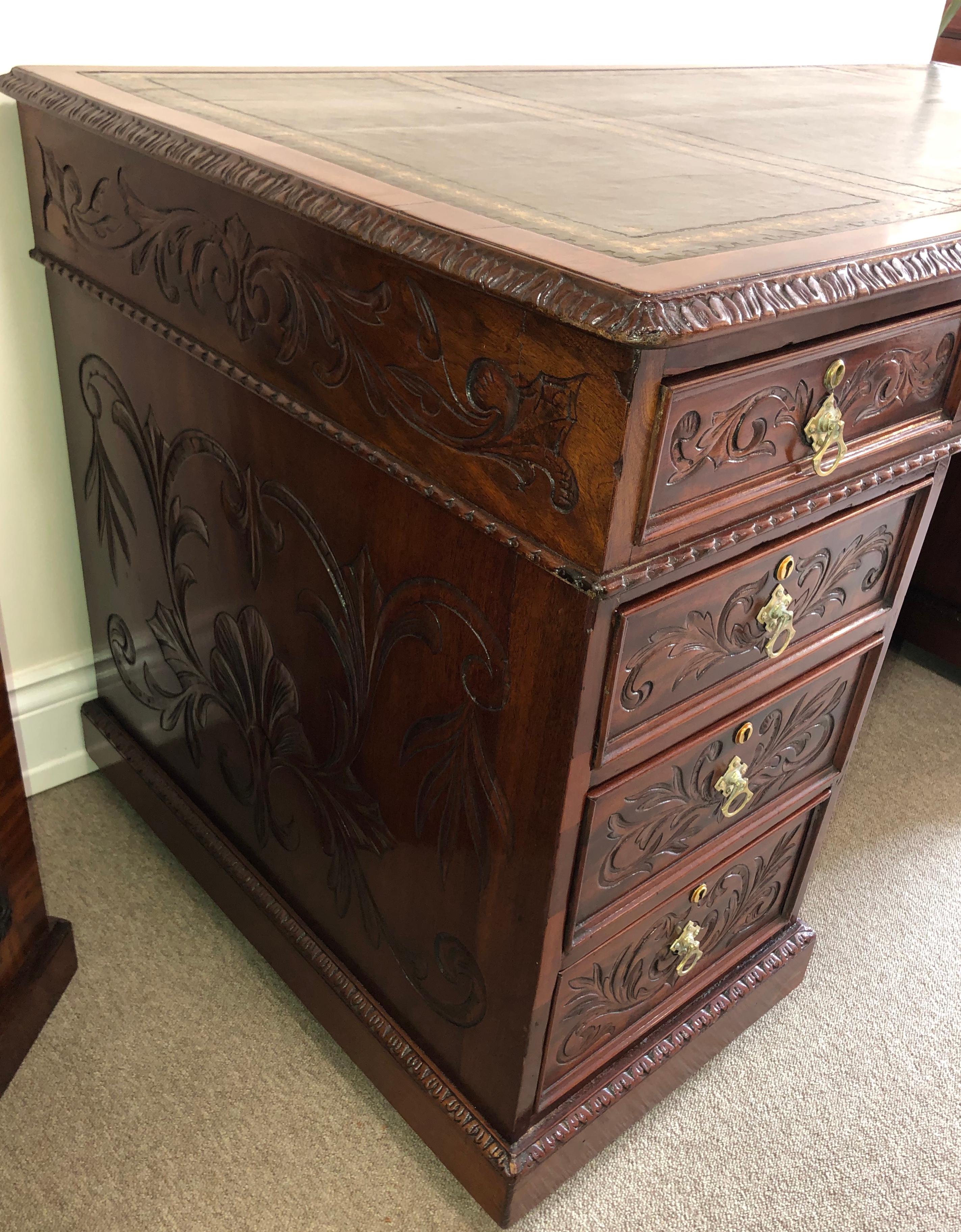Handsome three part solid mahogany superior quality desk by S&H Jewell & Co. of little queen St London, with beautiful floral carvings throughout and a gilt tooled leather top.