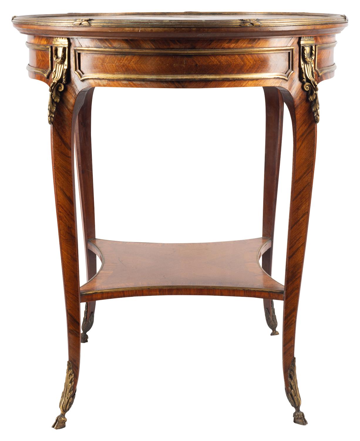 A fine quality 19th century French mahogany occasional table having radiating veneers from the centre, gilded ormolu mounts to the frieze and elegant cabriole legs that are united by a stretcher beneath.