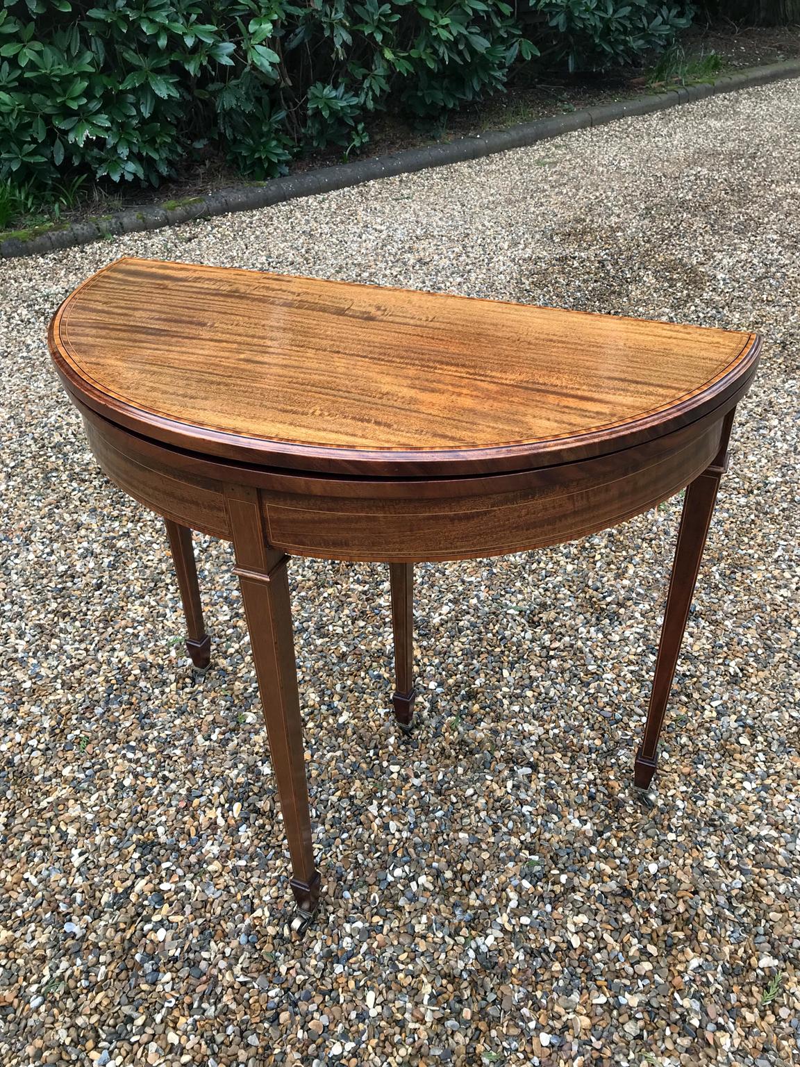 19th century late Victorian mahogany inlaid demilune card table with satinwood inlay on square tapering legs. With newly fitted baize.

circa 1890-1901

Dimensions:
Height: 29.5 inches - 76 cms
Width: 33 inches - 83 cms
Depth: 16 inches - 41