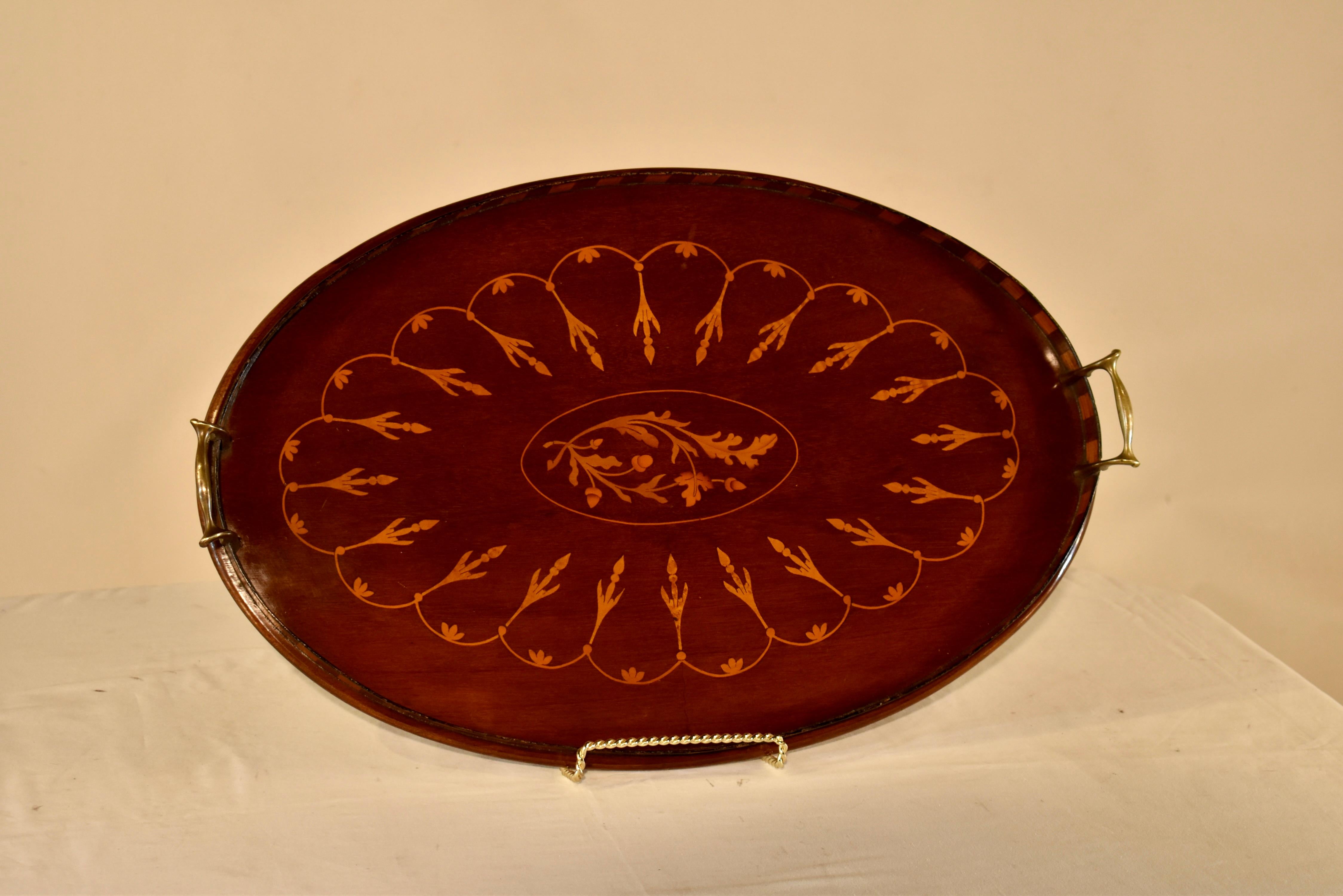 19th century mahogany tray from England inlaid in a lovely pattern with leaves and acorns.. Around the central lozenge of leaves and acorns, there is a scalloped pattern which borders the tray for added design interest.  The tray has a two toned
