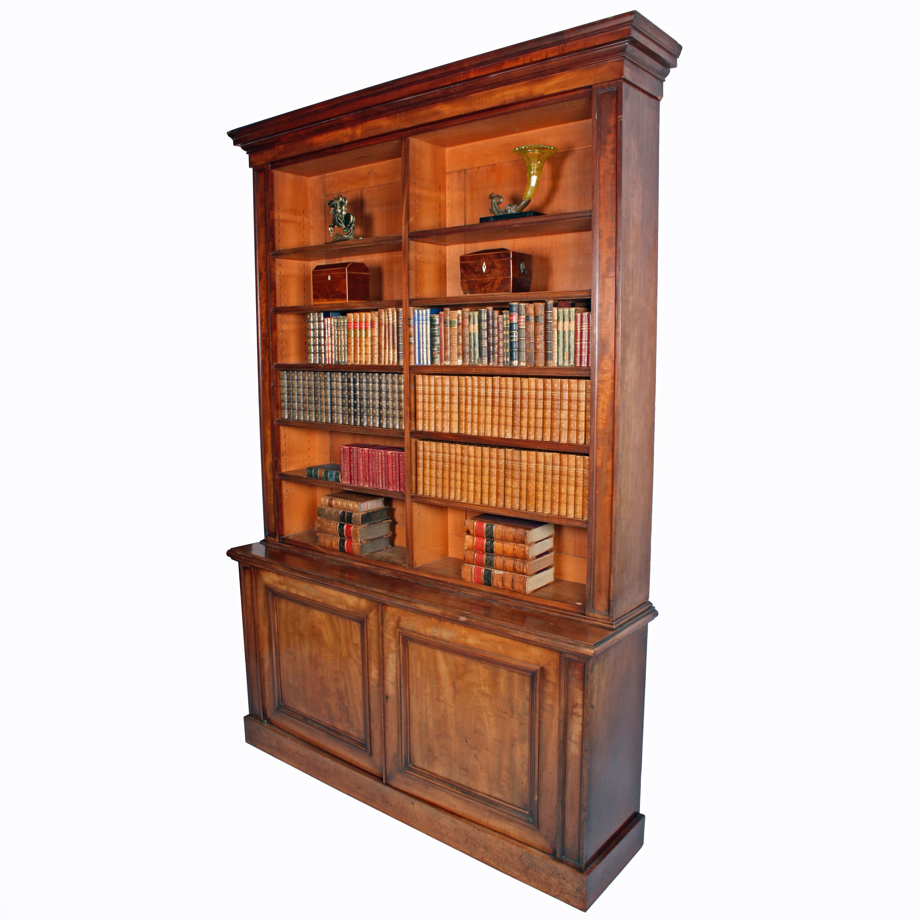 Mahogany library bookcase


A mid-19th century mahogany library bookcase.

The bookcase has an open shelf top and a two-door cupboard base. The bookcase top is divided down the centre and has ten adjustable shelves which have a concave and reeded