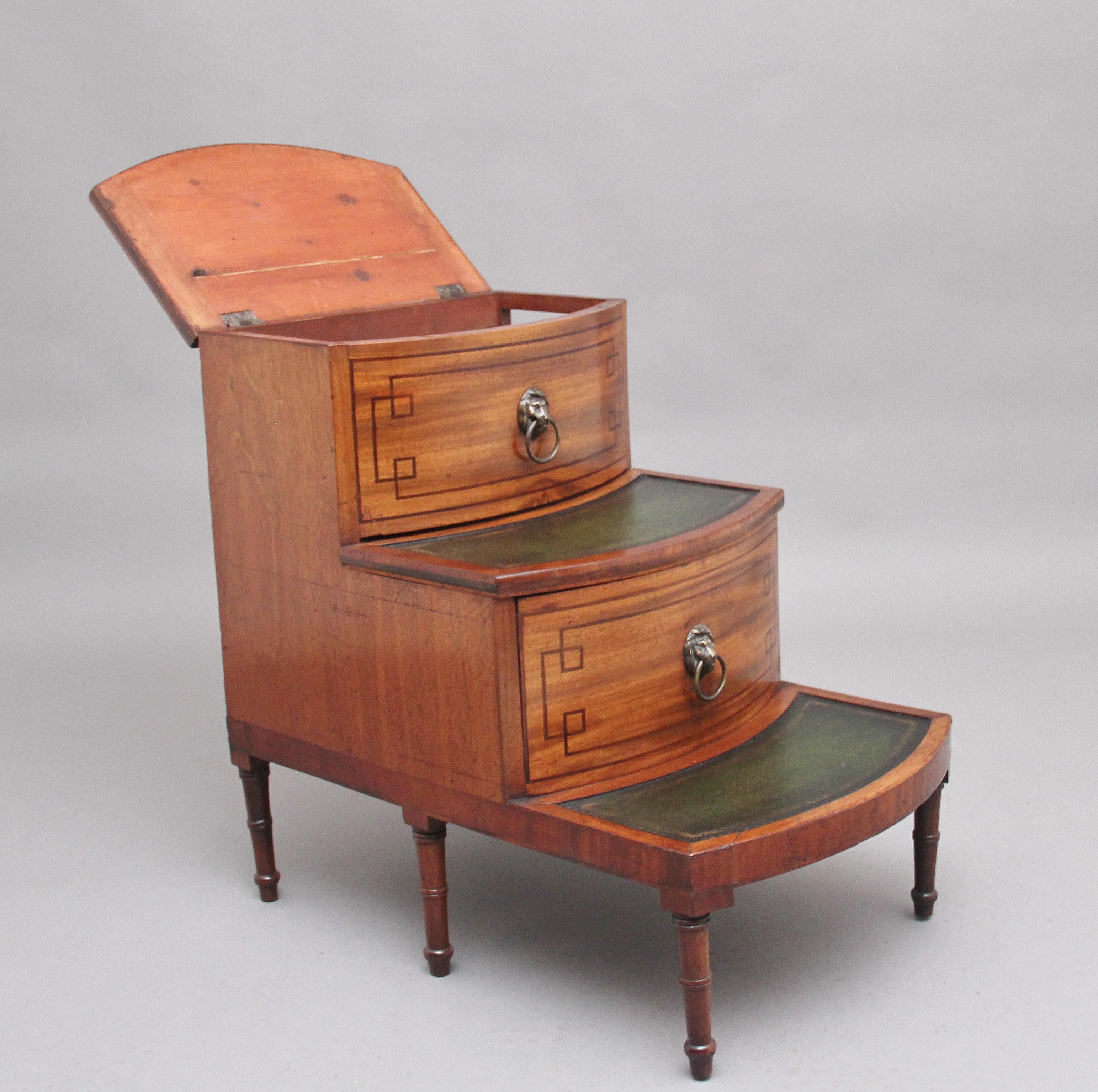 19th century mahogany library steps with three green leather lined steps decorated with blind and gold tooling, the top step having a hinged lift up lid to reveal a spacious compartment space, the front of each step having inlay decoration and