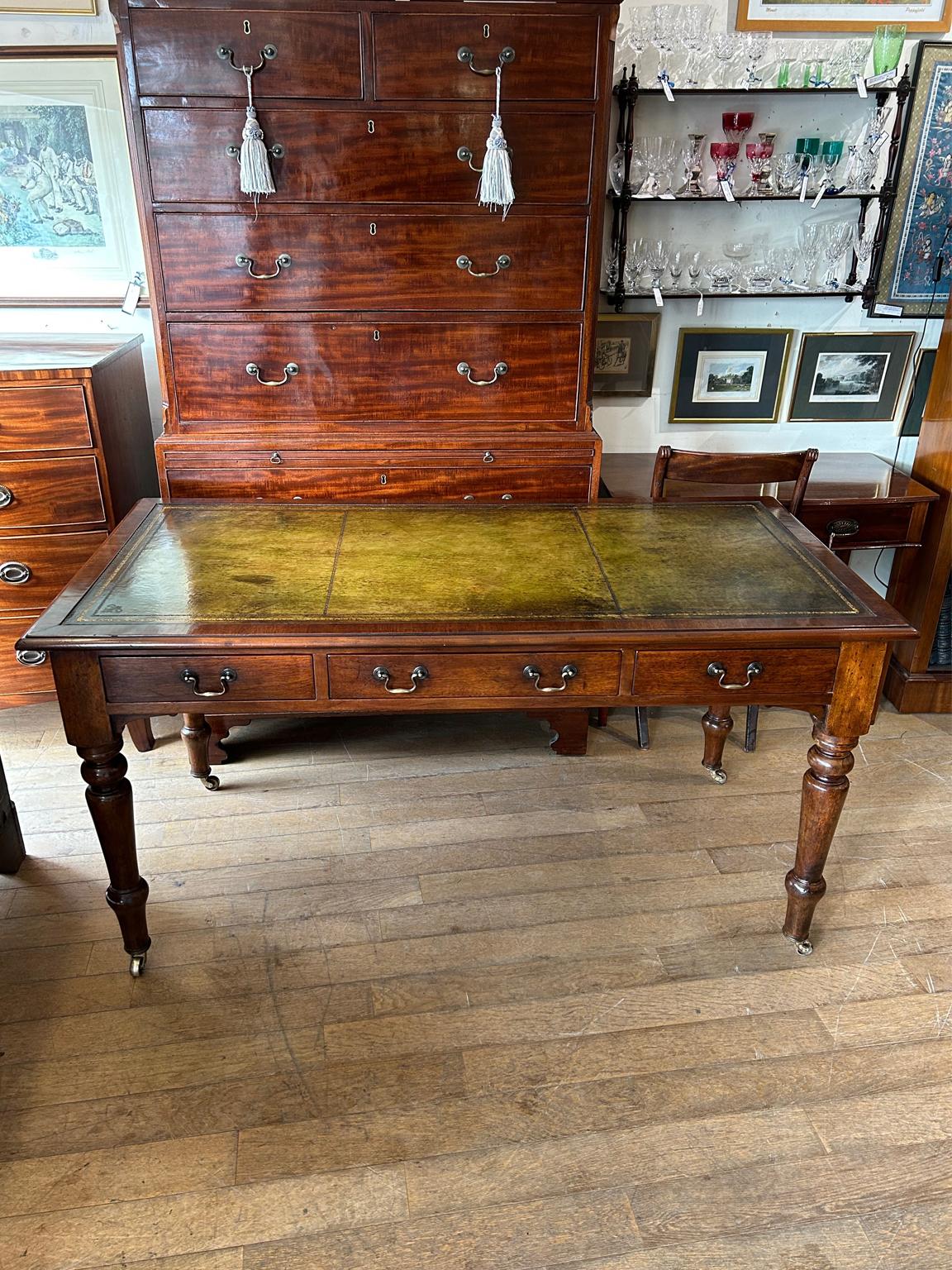 19th century Mahogany Library / writing table with green leathered writing surface, three drawers fitted with brass swan neck handles. On turned legs and brass original castors to base.

circa: 1850

Dimensions:
Width: 59.5 inches – 151