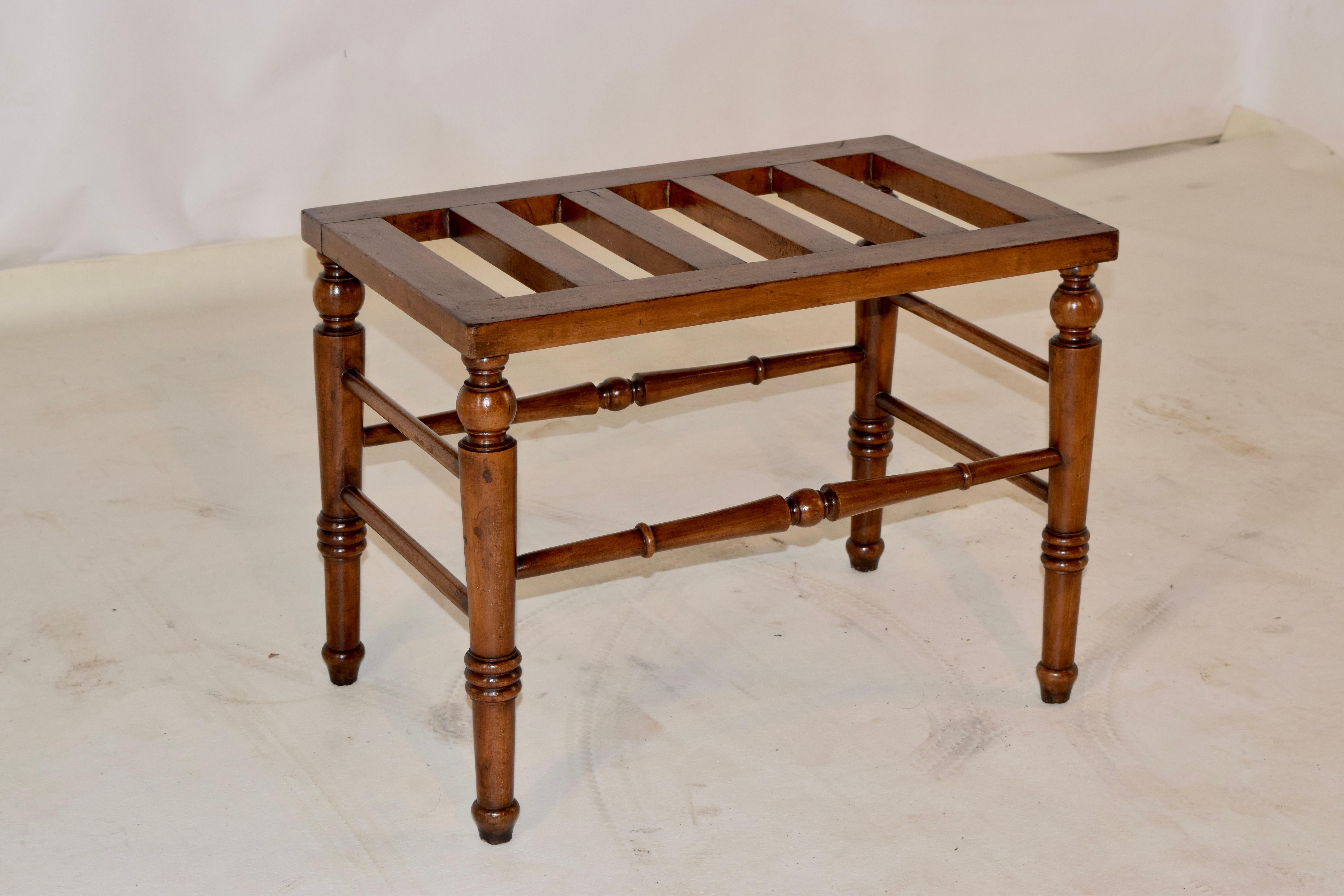 19th century English luggage stand made from Mahogany. The top is slatted, and ia supported on hand turned legs, which are slightly splayed and joined by stretchers.