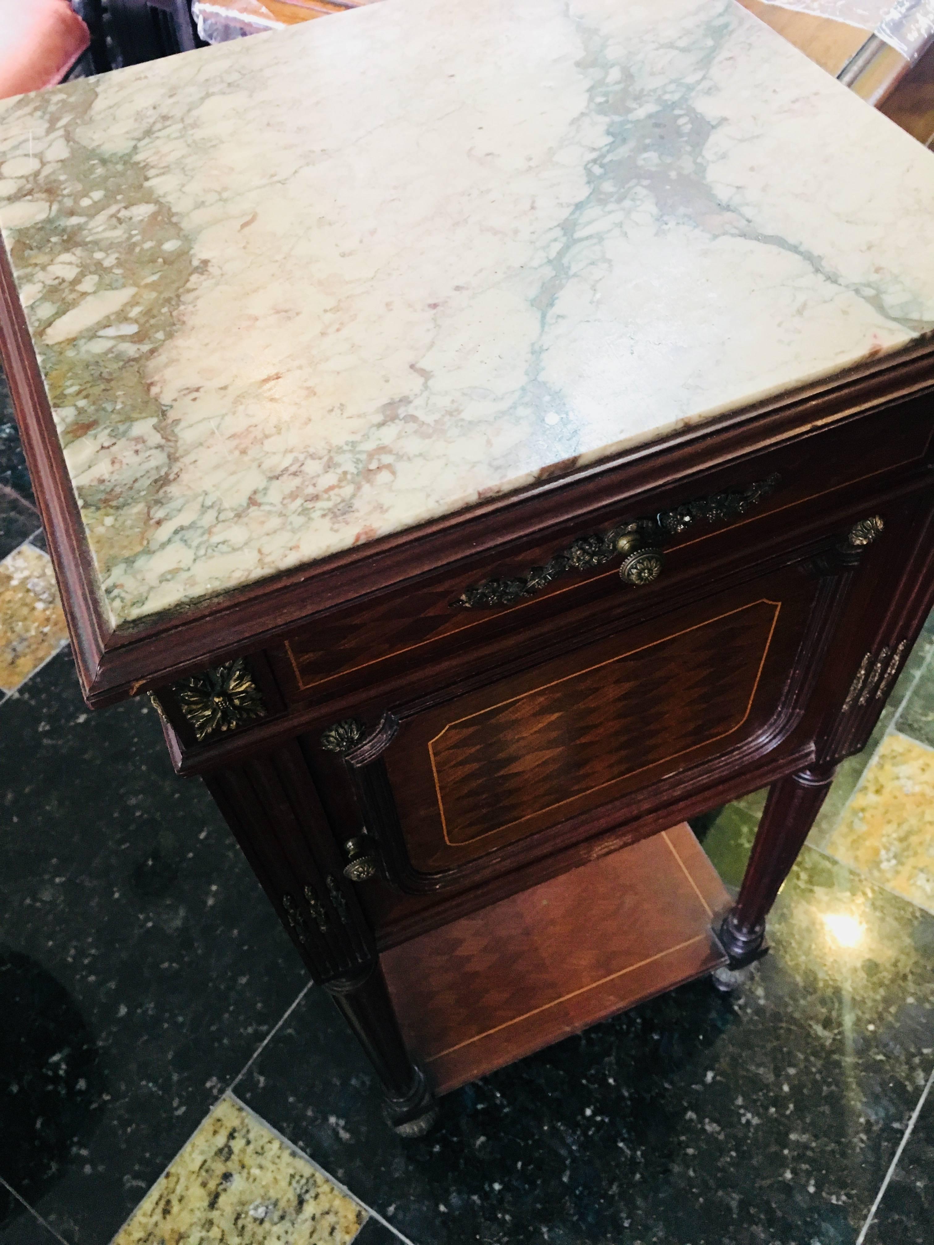 19th century mahogany marble-top nightstand with bronze decoration.
France, circa 1870.