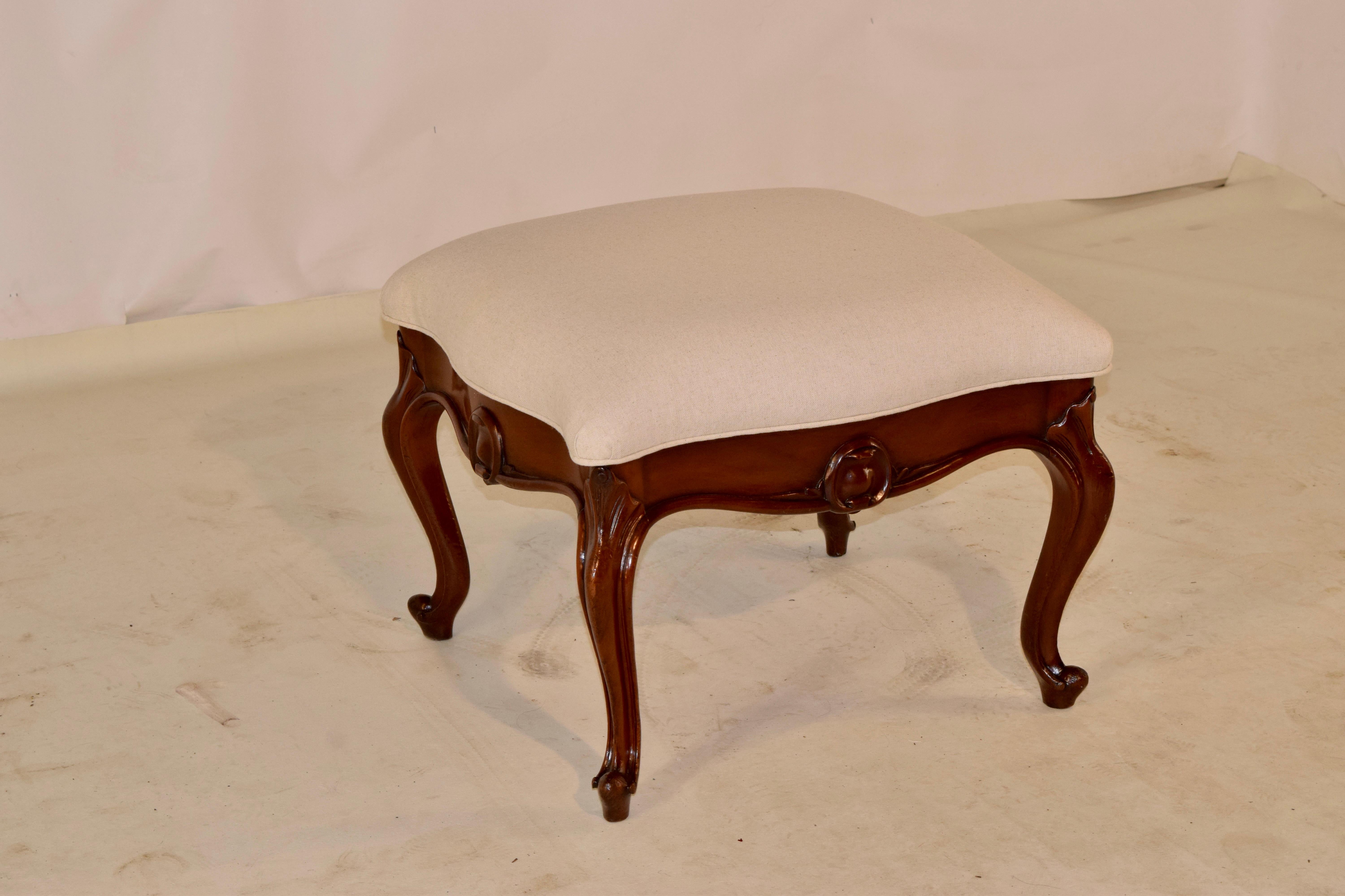 19th Century English lift top ottoman made from mahogany. The frame is serpentine shaped and has wonderfully hand-carved shells on the knees following down to the cabriole legs. The aprons also are decorated with hand carving and routed edges. The