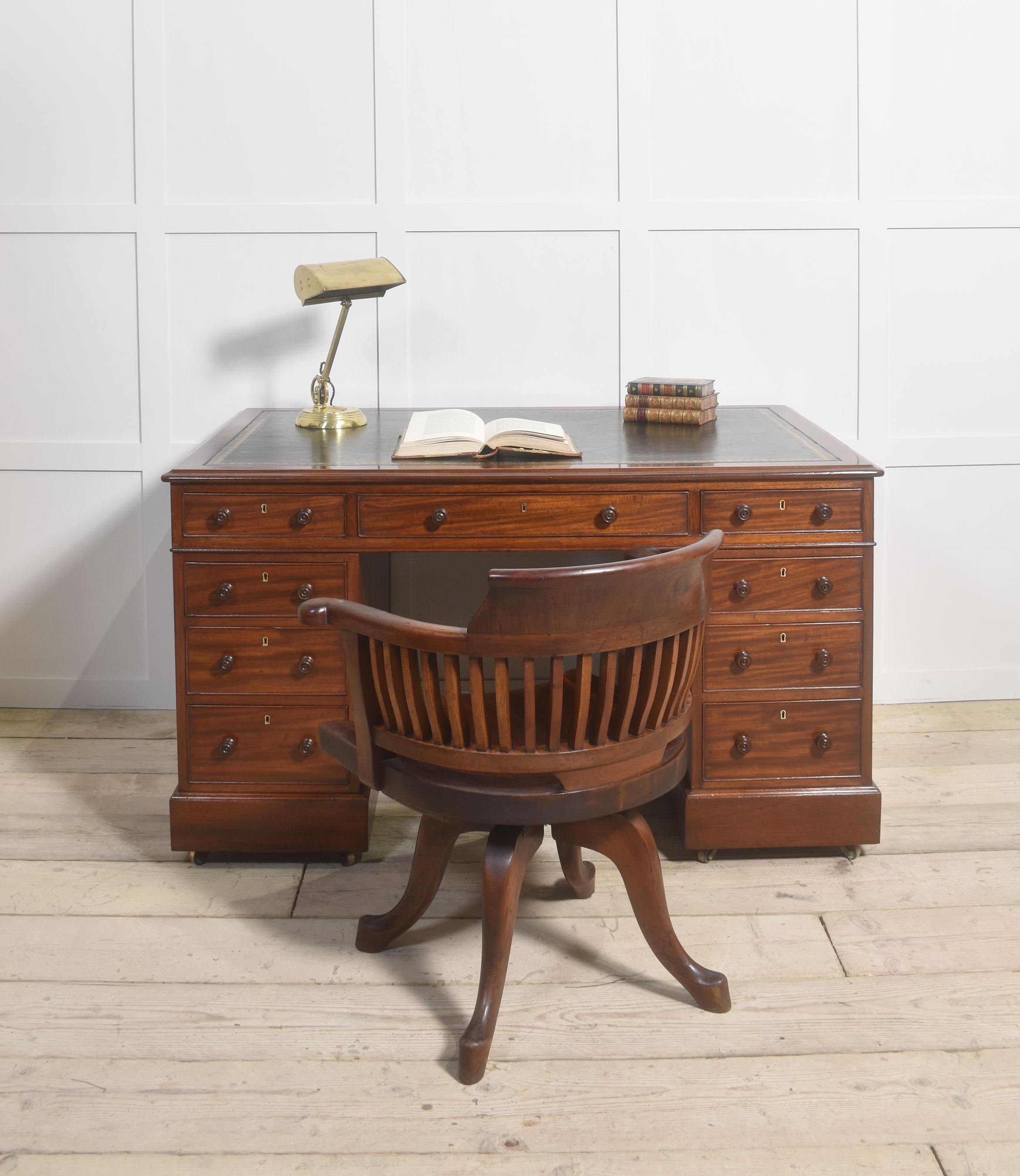 Victorian mahogany partners desk the rectangular top with inset leather having tooled border enclosed by a moulded edge over an arrangement of three freeze drawers. Above two pedestals one side with two banks of three drawers the opposing side