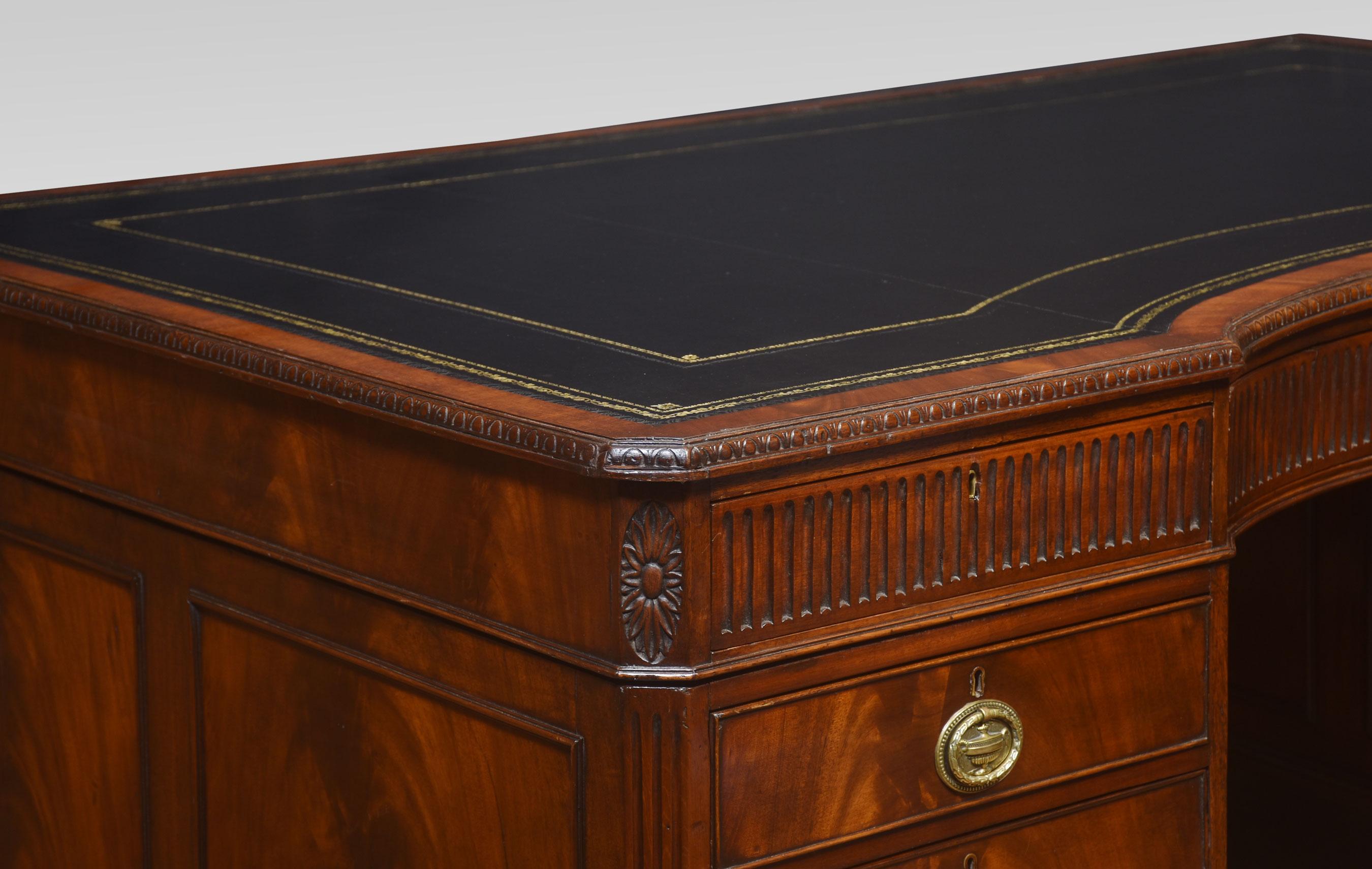 19th Century mahogany partners/library desk, the very large rectangular inverted bow front top inset with black hide and gilt-tooled border enclosed by a molded edge over an arrangement of three frieze drawers. Above two large pedestals having three