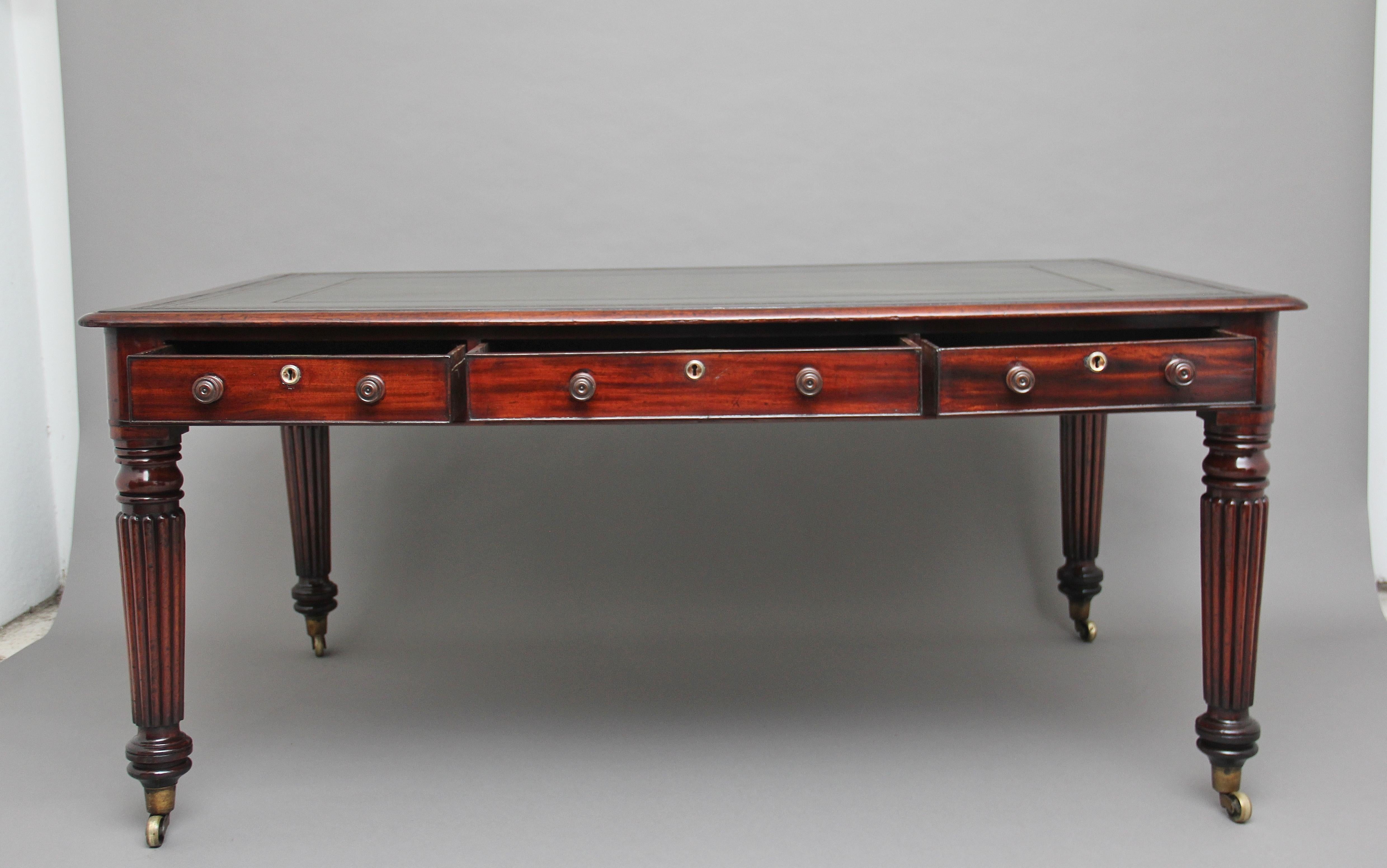 A lovely quality mid 19th Century mahogany partners writing desk / table, the moulded edge top with mahogany crossbanding, having a green leather writing surface decorated with gold and blind tooling, having six mahogany lined frieze drawers with