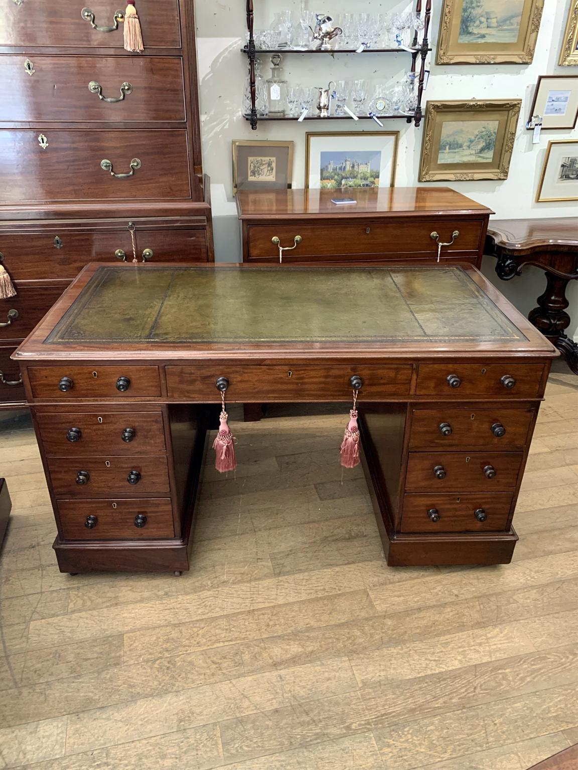 19th century Mahogany pedestal desk, the top with a leather writing surface and nine drawers, all with fitted with turned wooden handles and mahogany drawers. Comes apart in three separate sections.