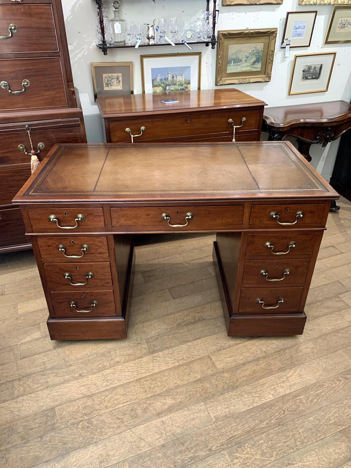 19th century Mahogany pedestal desk, the top with a leather writing surface and nine drawers, all with fitted with brass swan neck handles and oak lined drawers. Comes apart in three separate sections with working key.
   