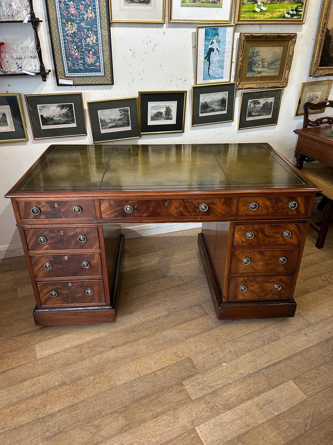 19th century Mahogany pedestal desk, the top with a leather writing surface and nine drawers, all with fitted with brass ring handles and oak lined drawers. Comes apart in three separate sections with working key.

circa: