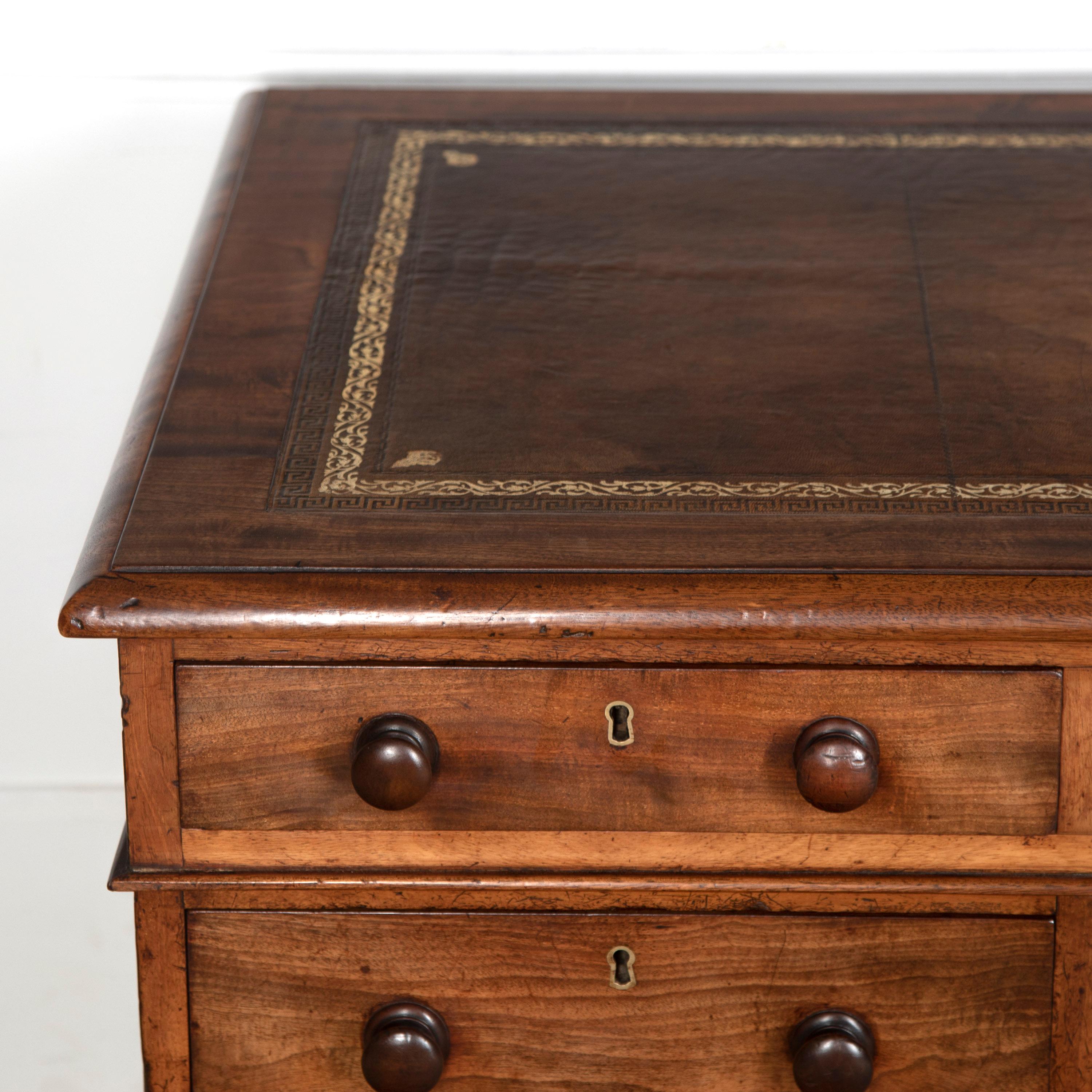 Fine quality 19th century mahogany pedestal desk. 

This classic desk retains its original gilt-tooled tan leather top. Across the frieze are two short drawers and one long one.

There are a further three drawers to each pedestal, all with