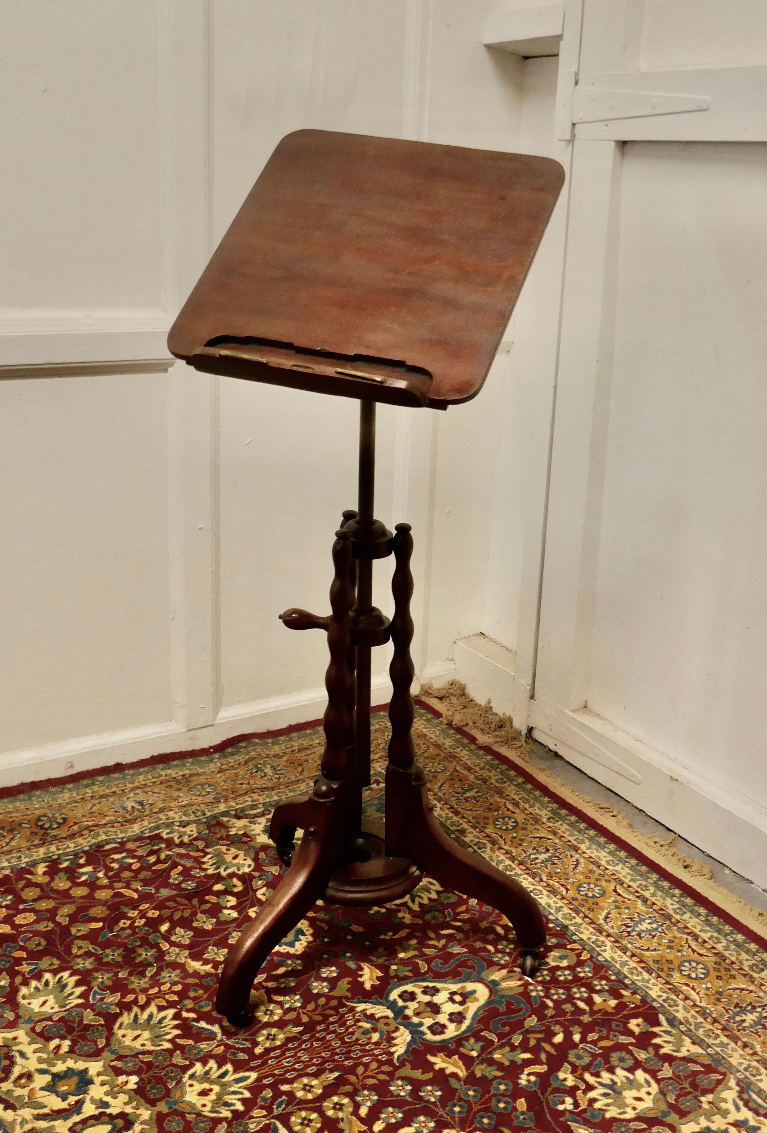 19th century Mahogany reading or music stand

A very fine quality piece, the stand has an attractive bobin turned base with a brass upright column which carries a small mahogany table top, with a concealed book rest with page clasps
The Table top