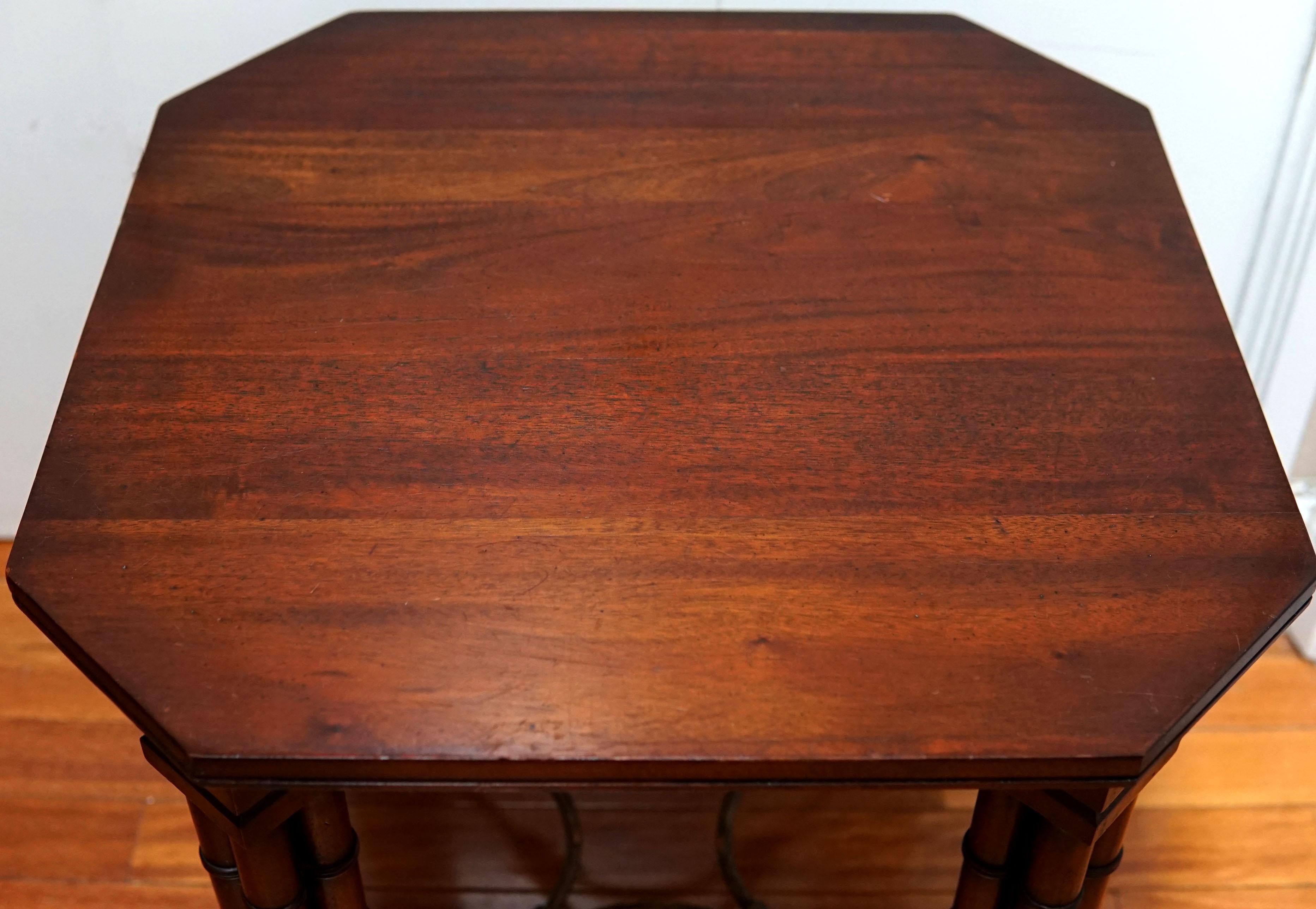 A rare mahogany occasional table from England circa the late 1800s has canted corners and acorn feet. This is a unique piece with distinctive handcrafting. The overall appearance is distinctive. The mahogany has a reddish tone with a deep patina.
